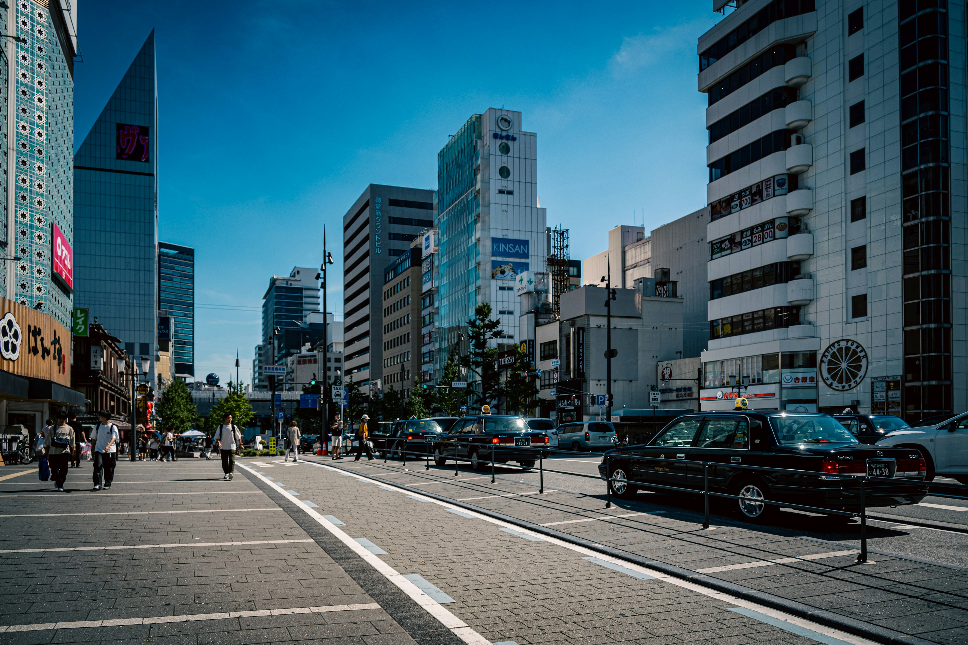 Urban street scene with tall buildings and vehicles