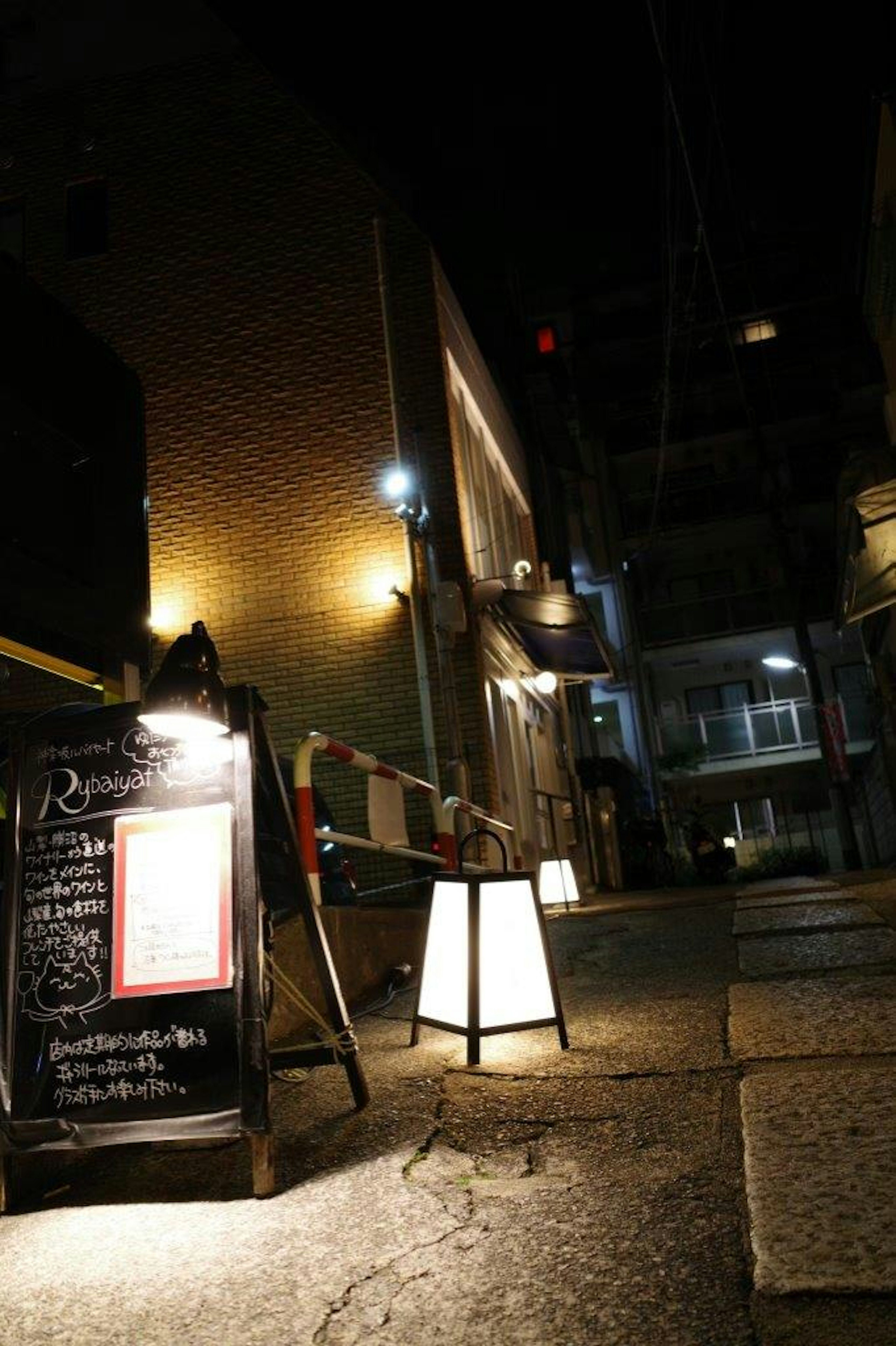 Restaurant-Schild und Beleuchtung an einer nächtlichen Straßenecke