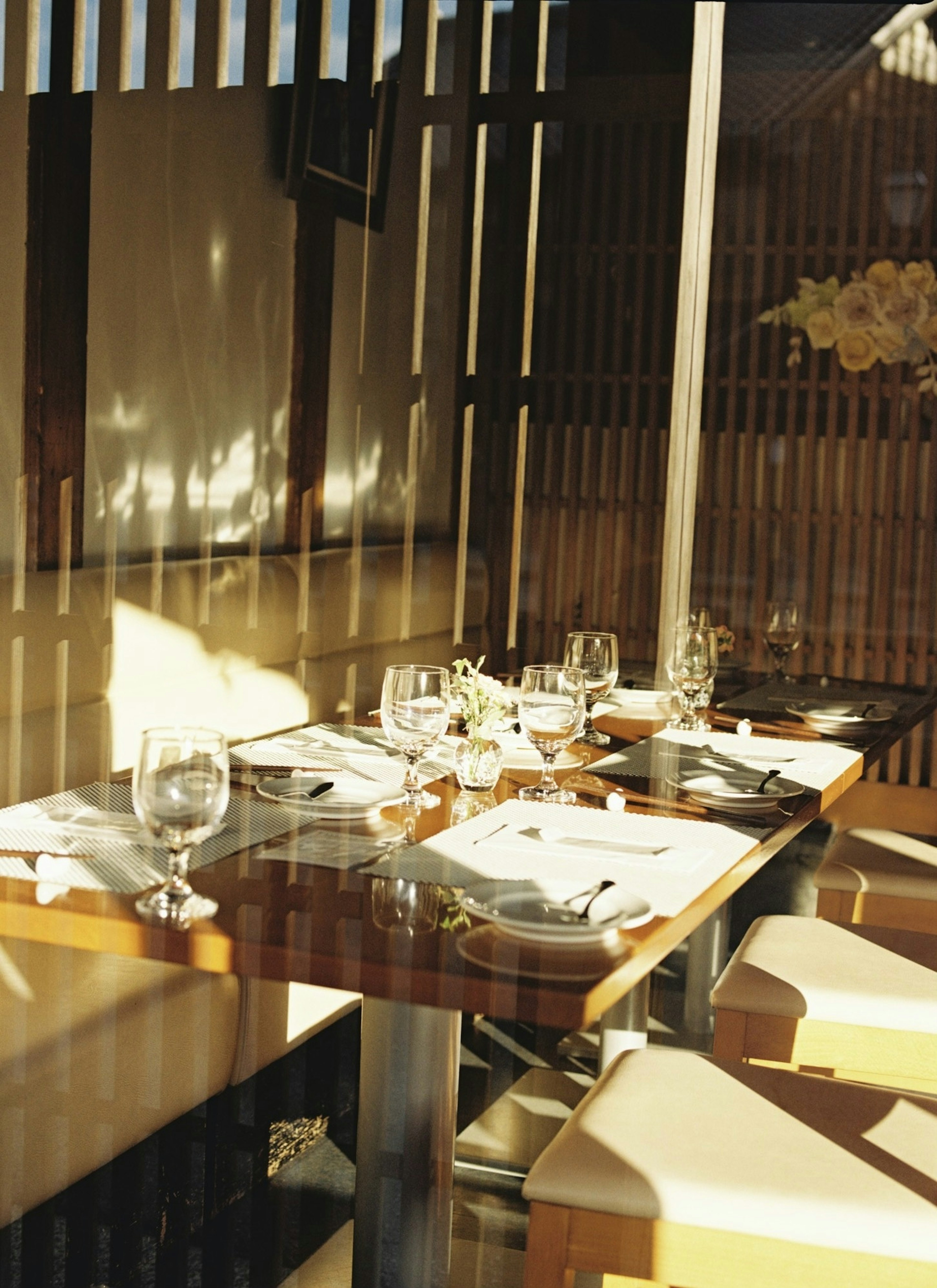 A bright restaurant table setting with elegant glassware and cutlery