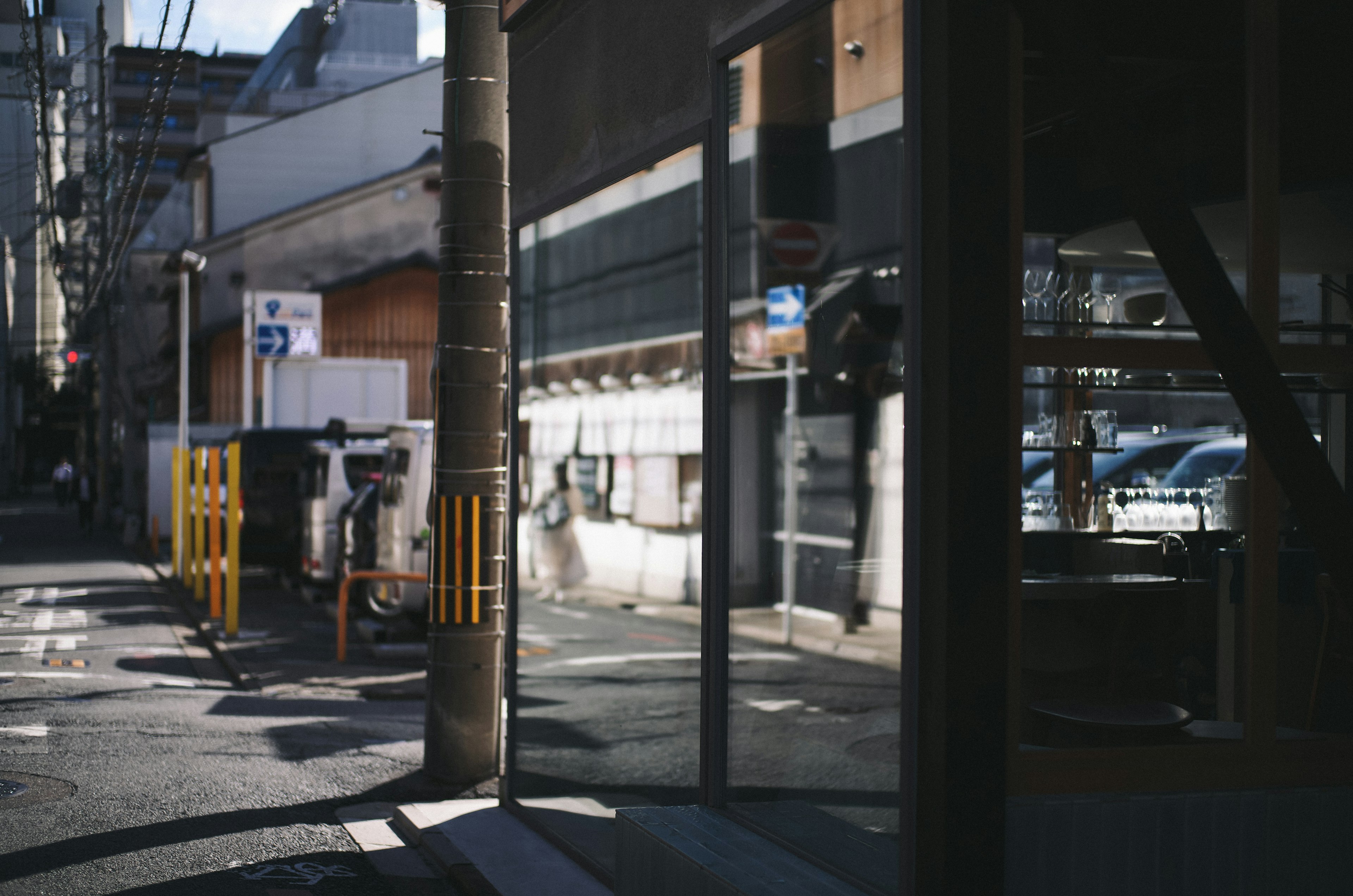 Quiet street scene showing reflections and building facades