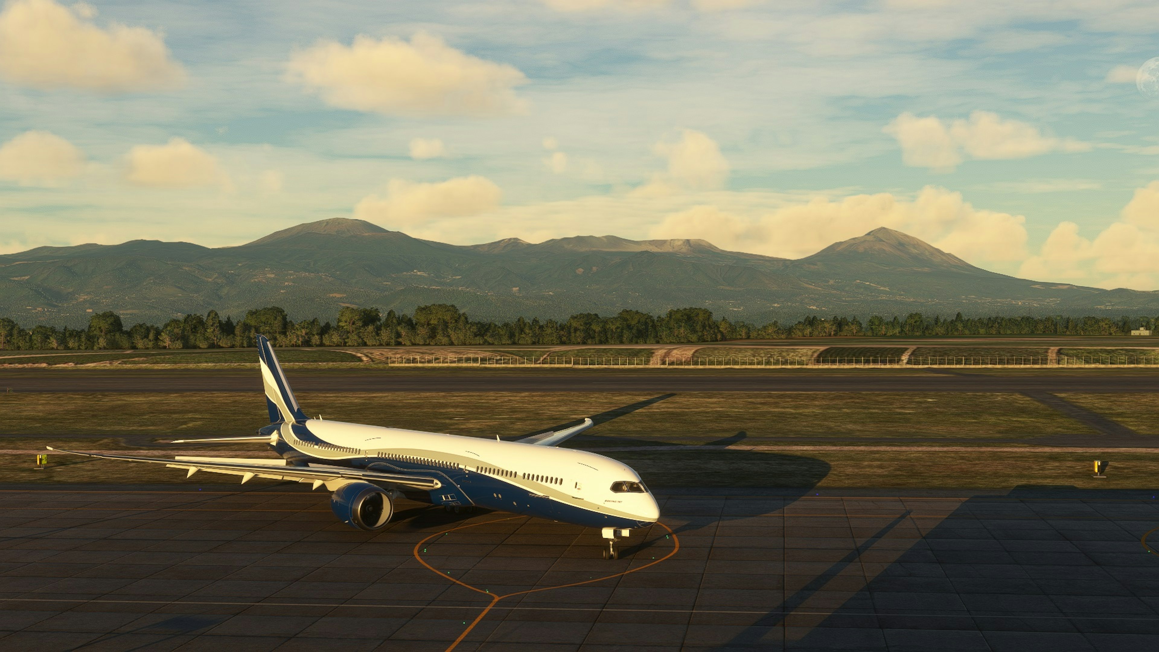 Airplane parked at the airport with mountains in the background