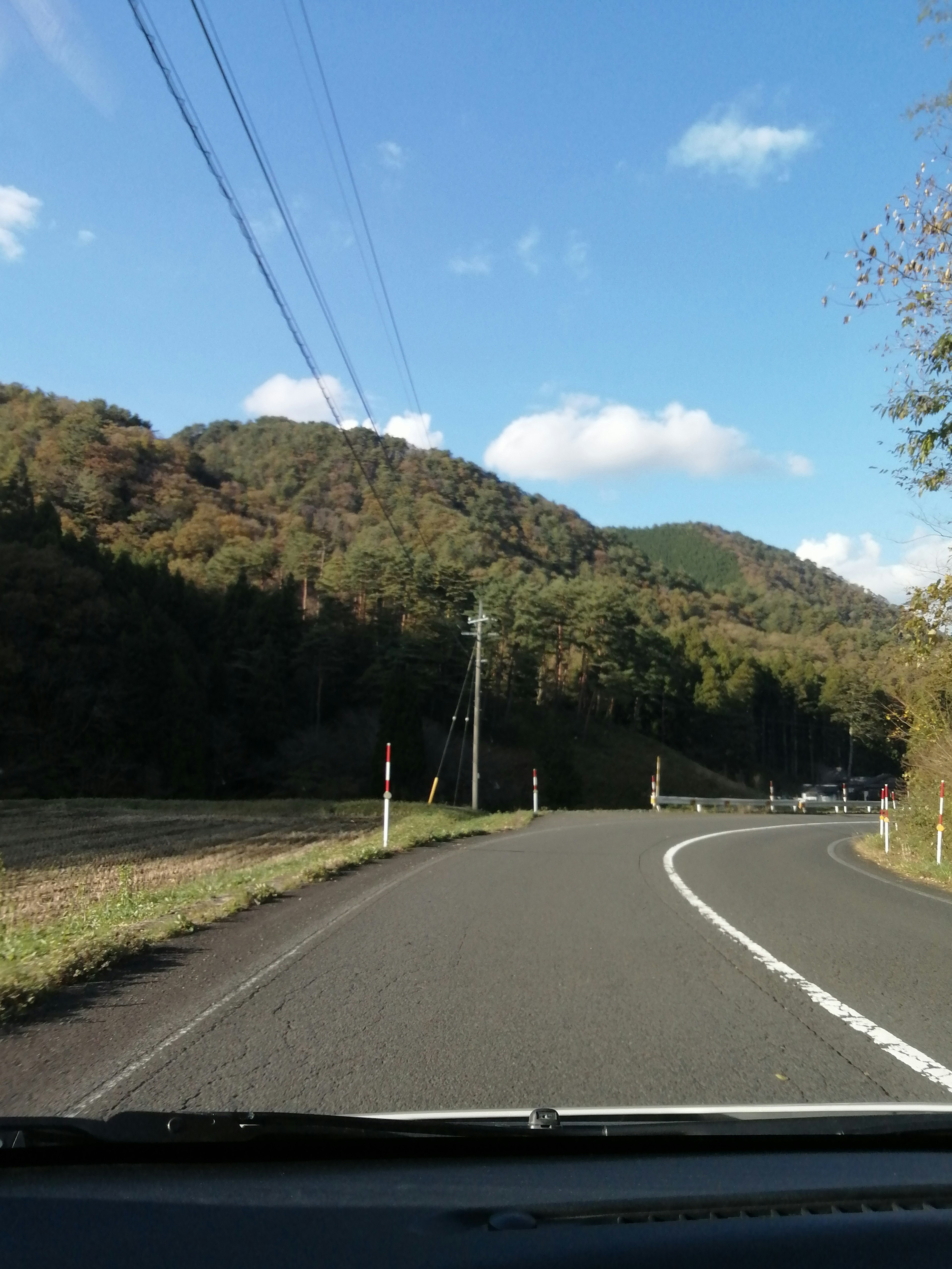 Scenic view of a winding road surrounded by green hills