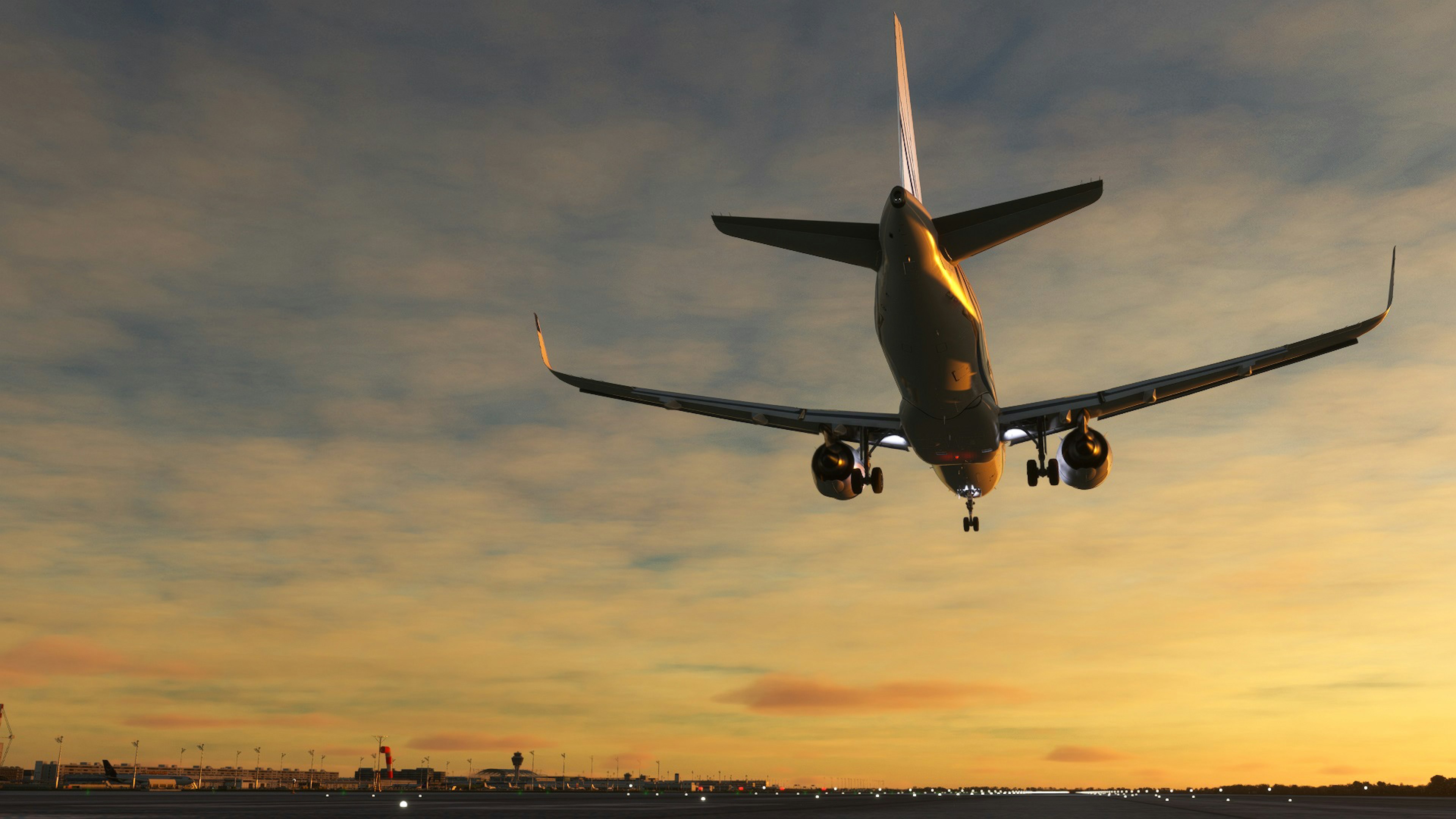 Avión aterrizando contra un cielo al atardecer