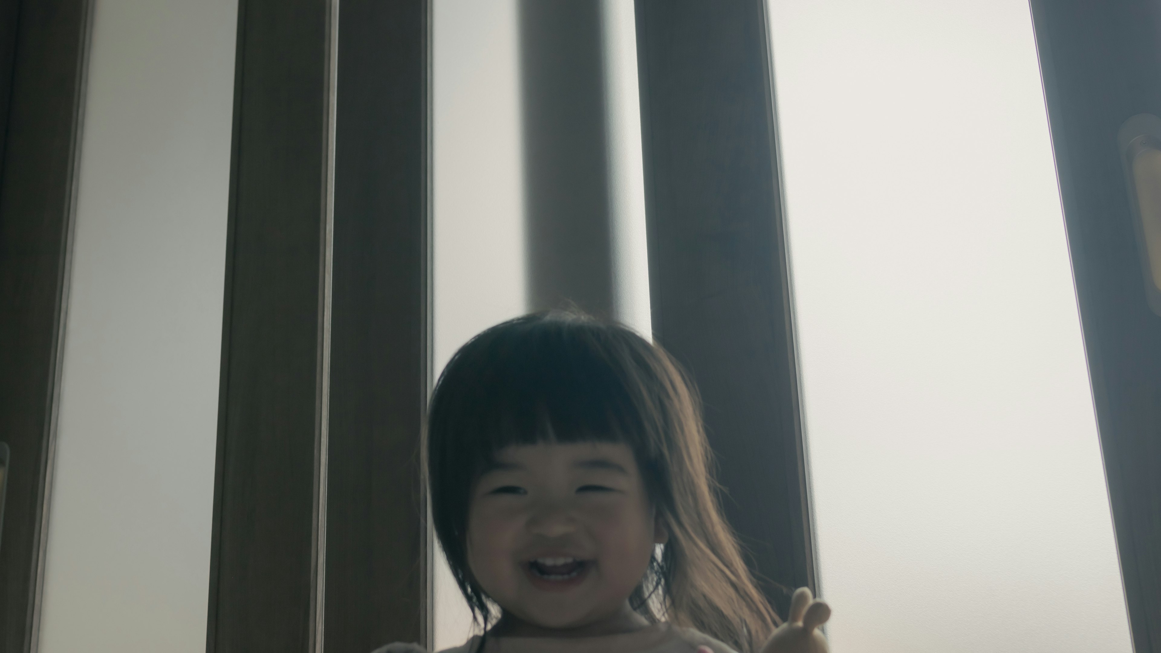 Smiling young girl near bright window