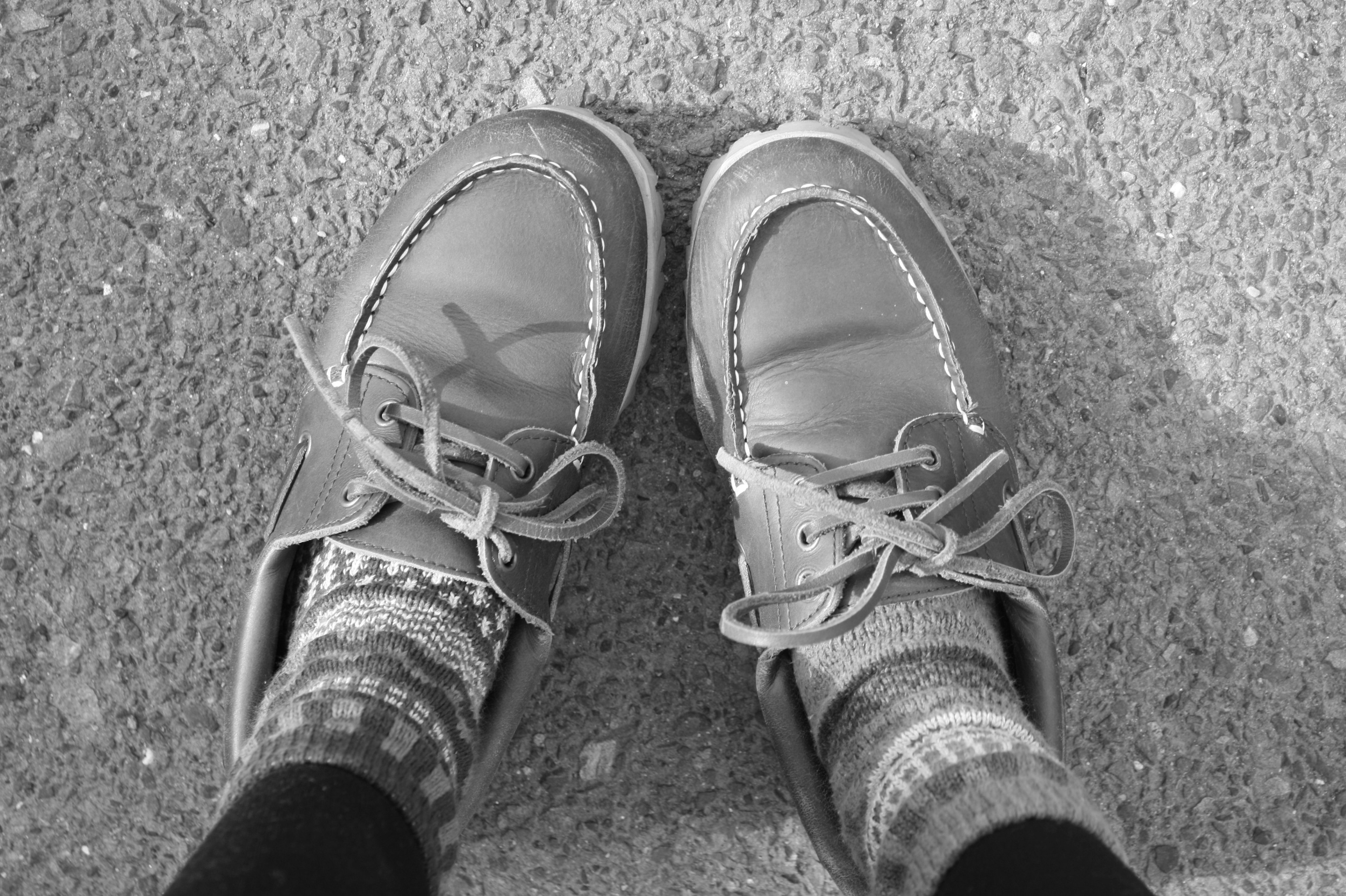 Black and white photo of shoes and colorful socks