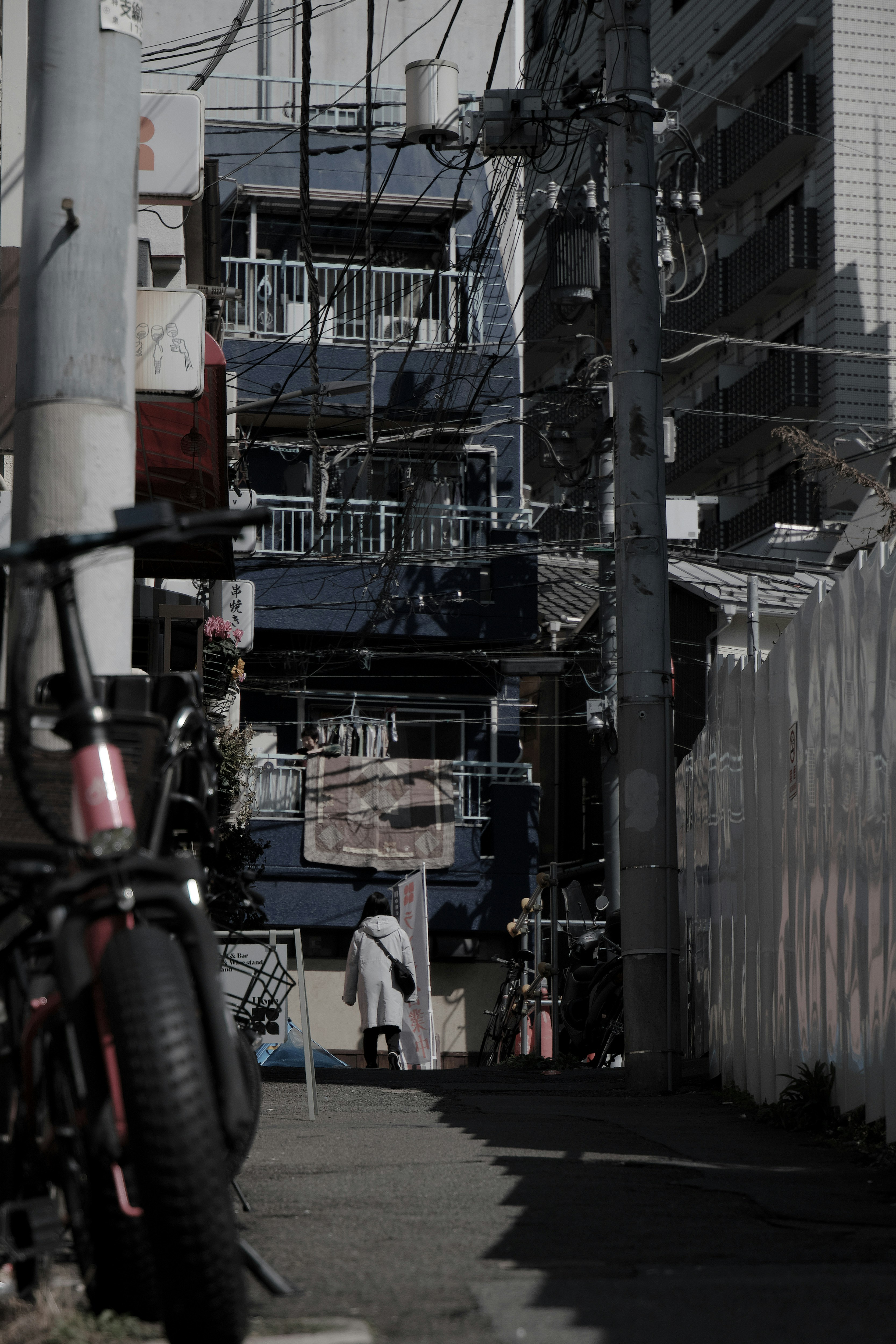 Narrow alley with a bicycle in the foreground and buildings in the background