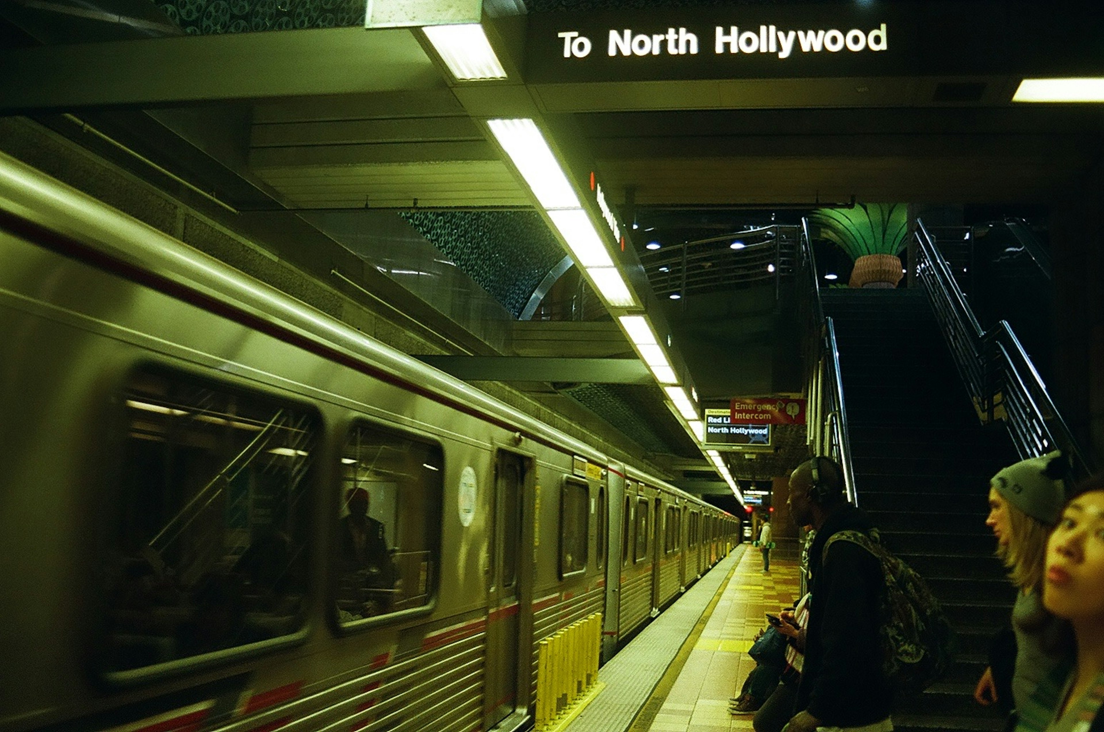 Subway station scene with sign to North Hollywood passengers waiting