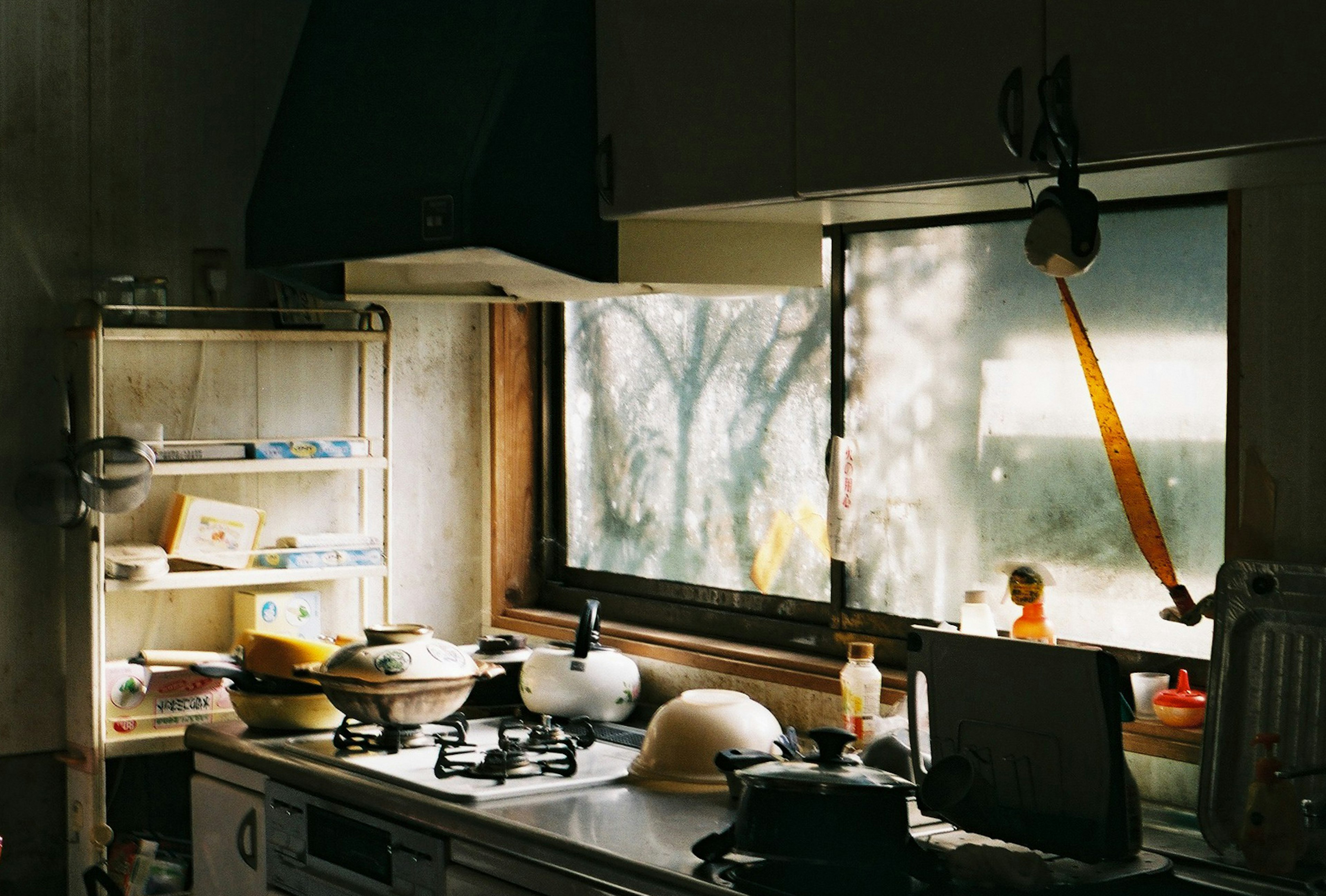 A cozy kitchen with sunlight streaming through the window and dishes on the counter