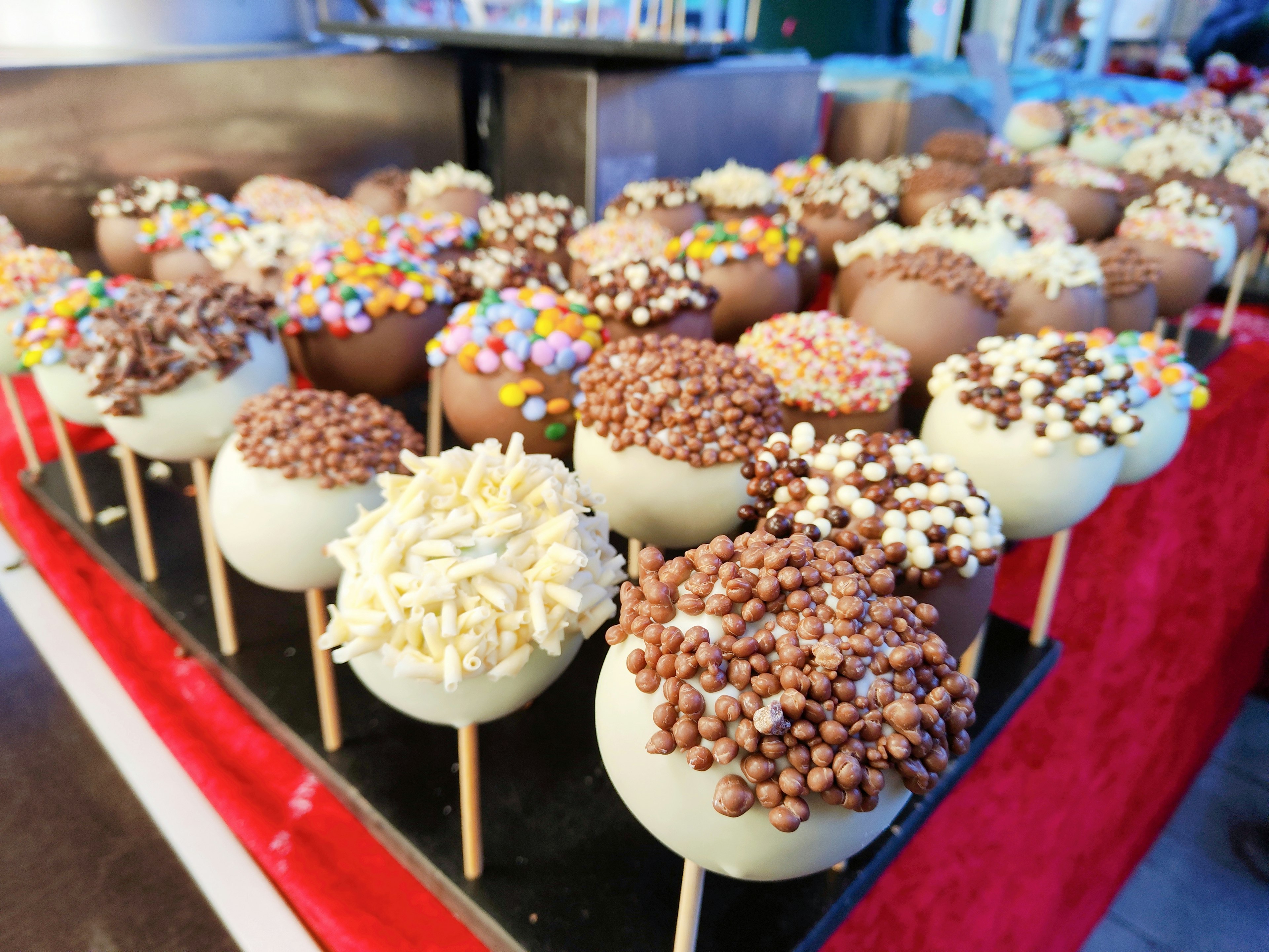 Display of chocolate pops with colorful toppings