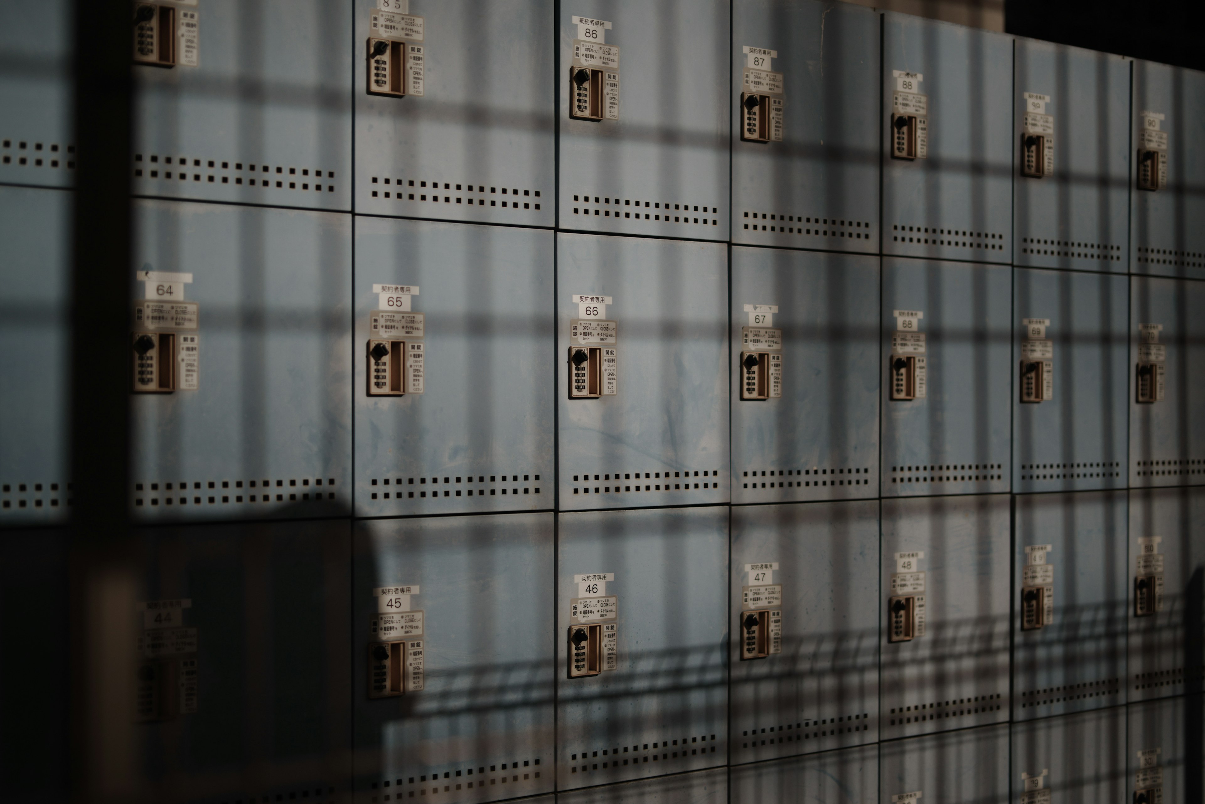 Image of a blue locker wall with shadows