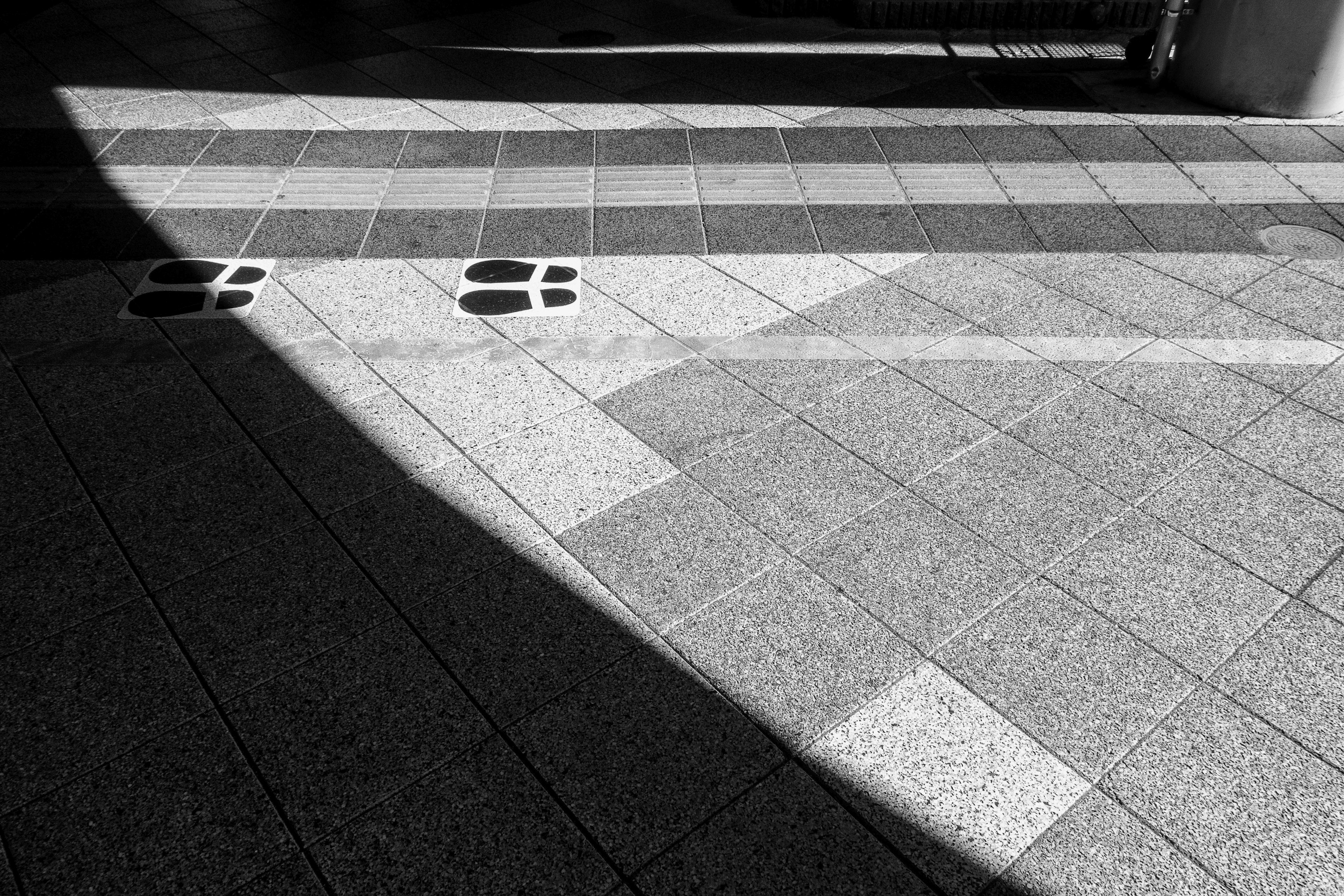 Black and white tiled ground with shadows