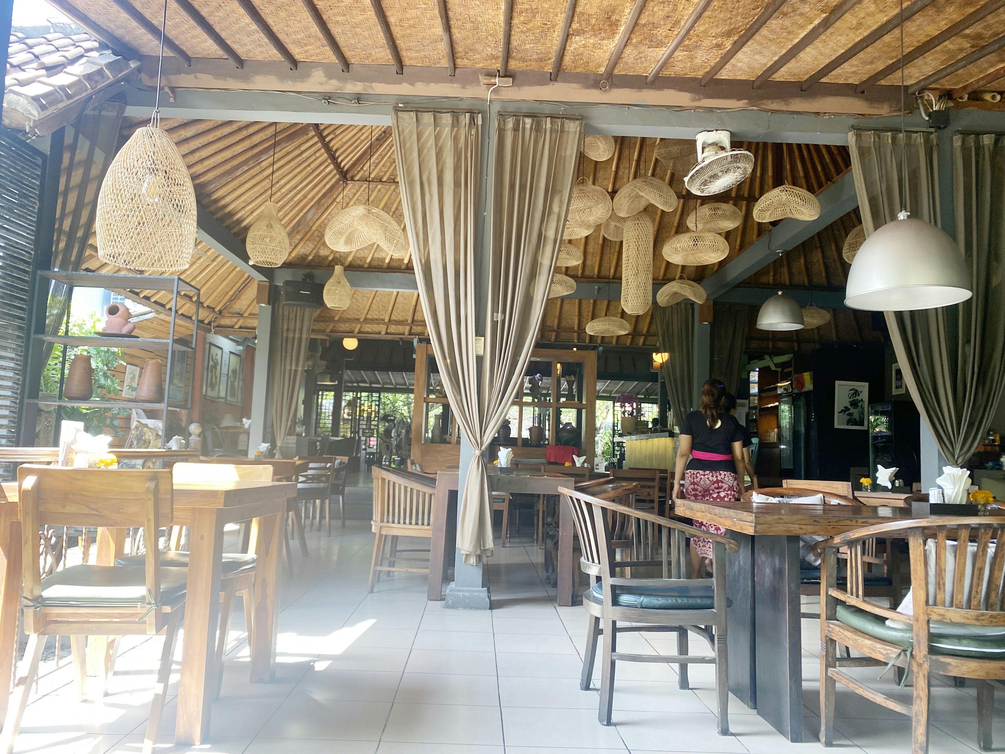 Interior of a cafe with natural light wooden furniture and unique hanging lights