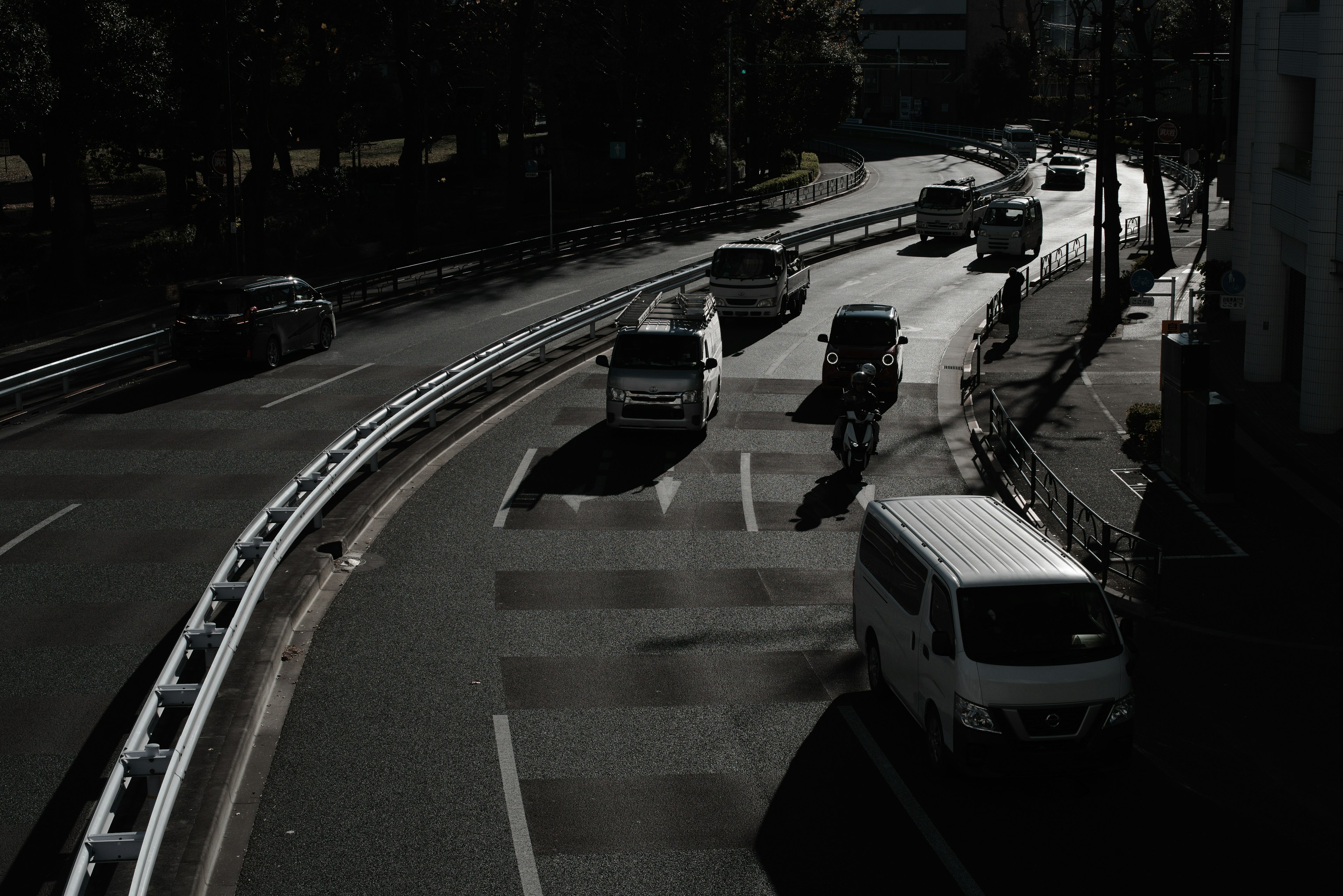 Scene of vehicles and a bicycle on a dark road