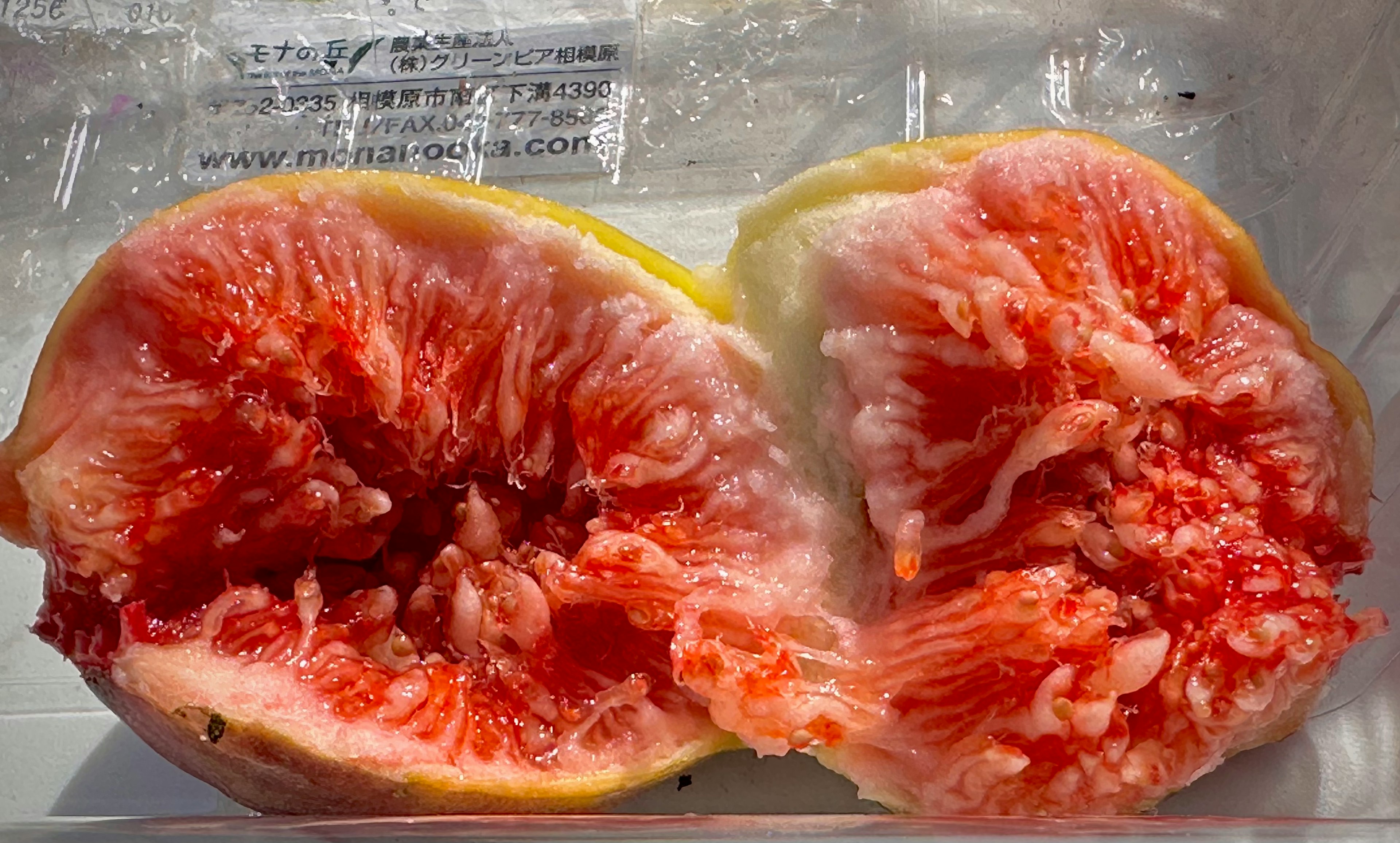 Image of a sliced fig showing its interior Ripe pink flesh with a creamy texture