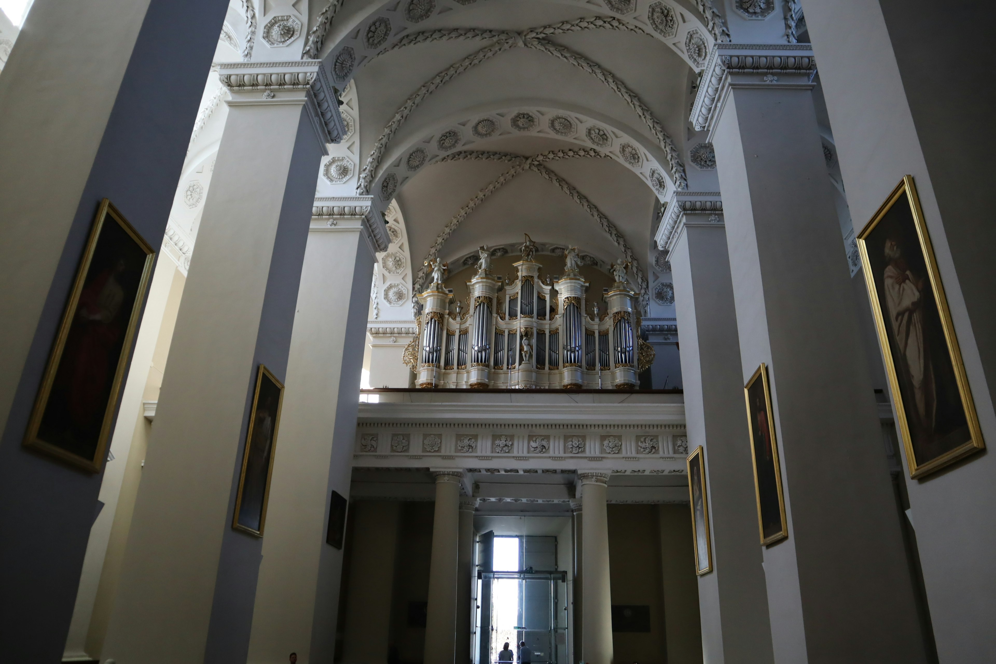 Interior of a historic building featuring large arched ceilings and decorative columns