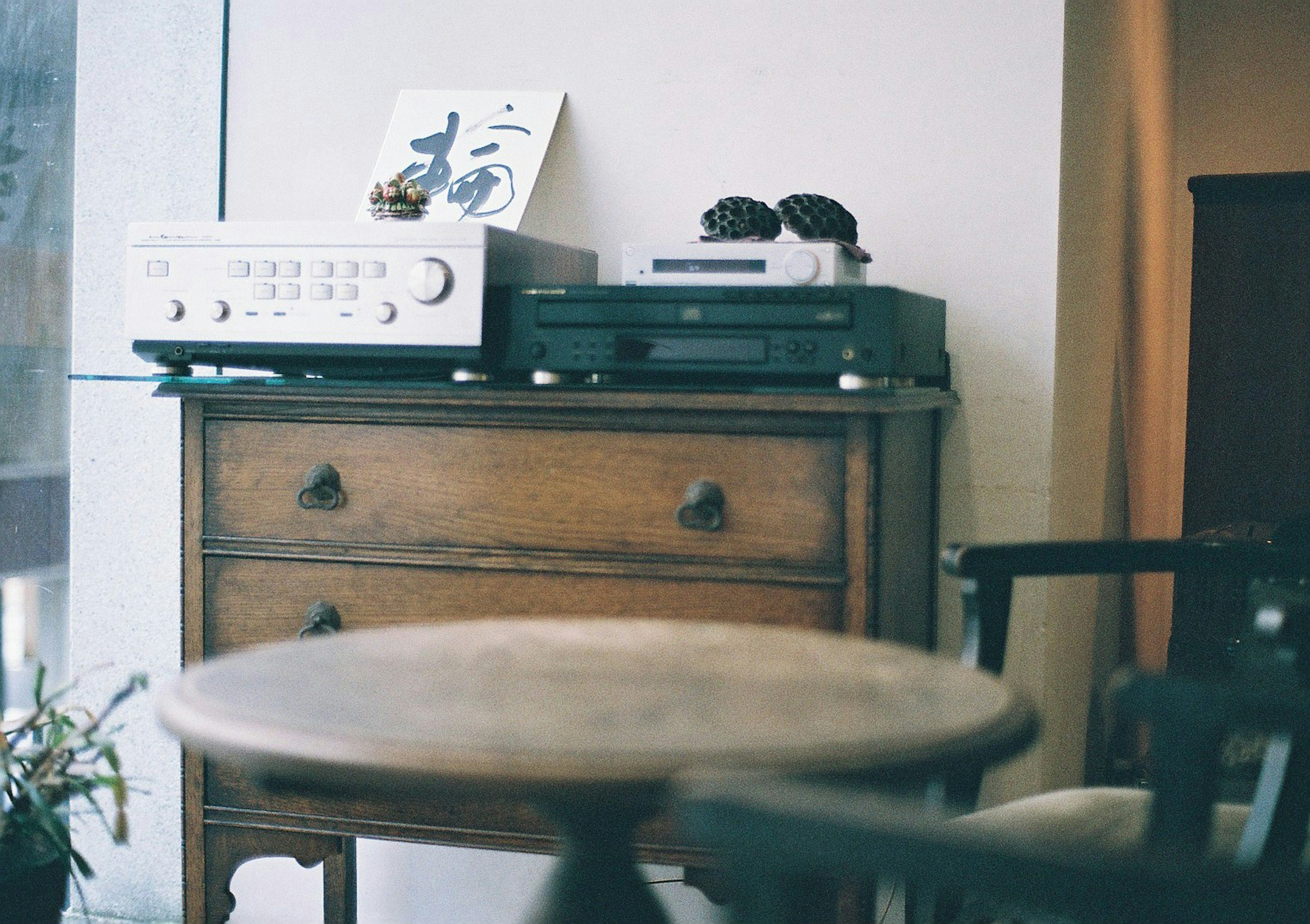 Antique wooden cabinet featuring audio equipment and a book