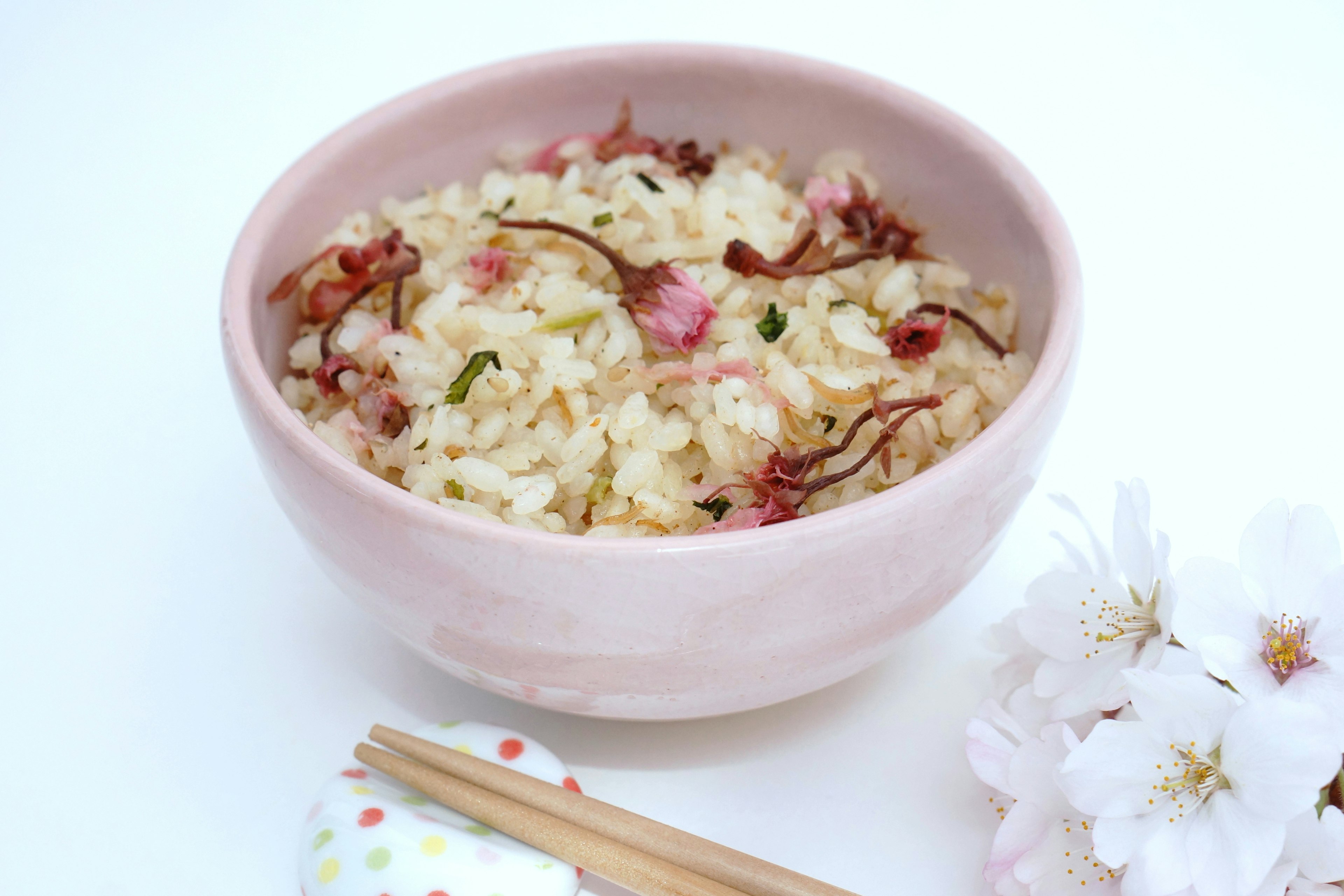 Bowl of rice porridge topped with cherry blossoms