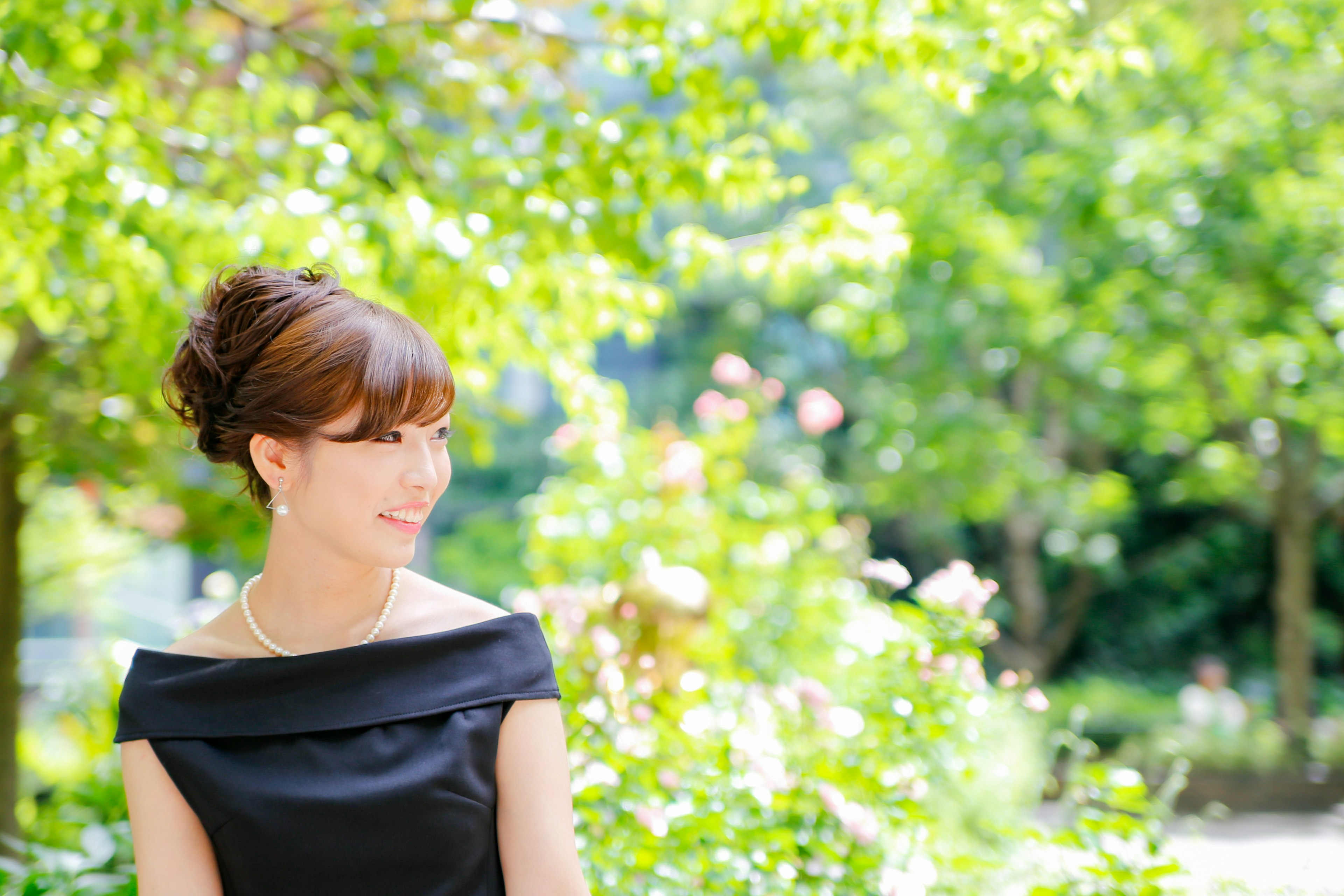 Portrait of a woman smiling in a green background