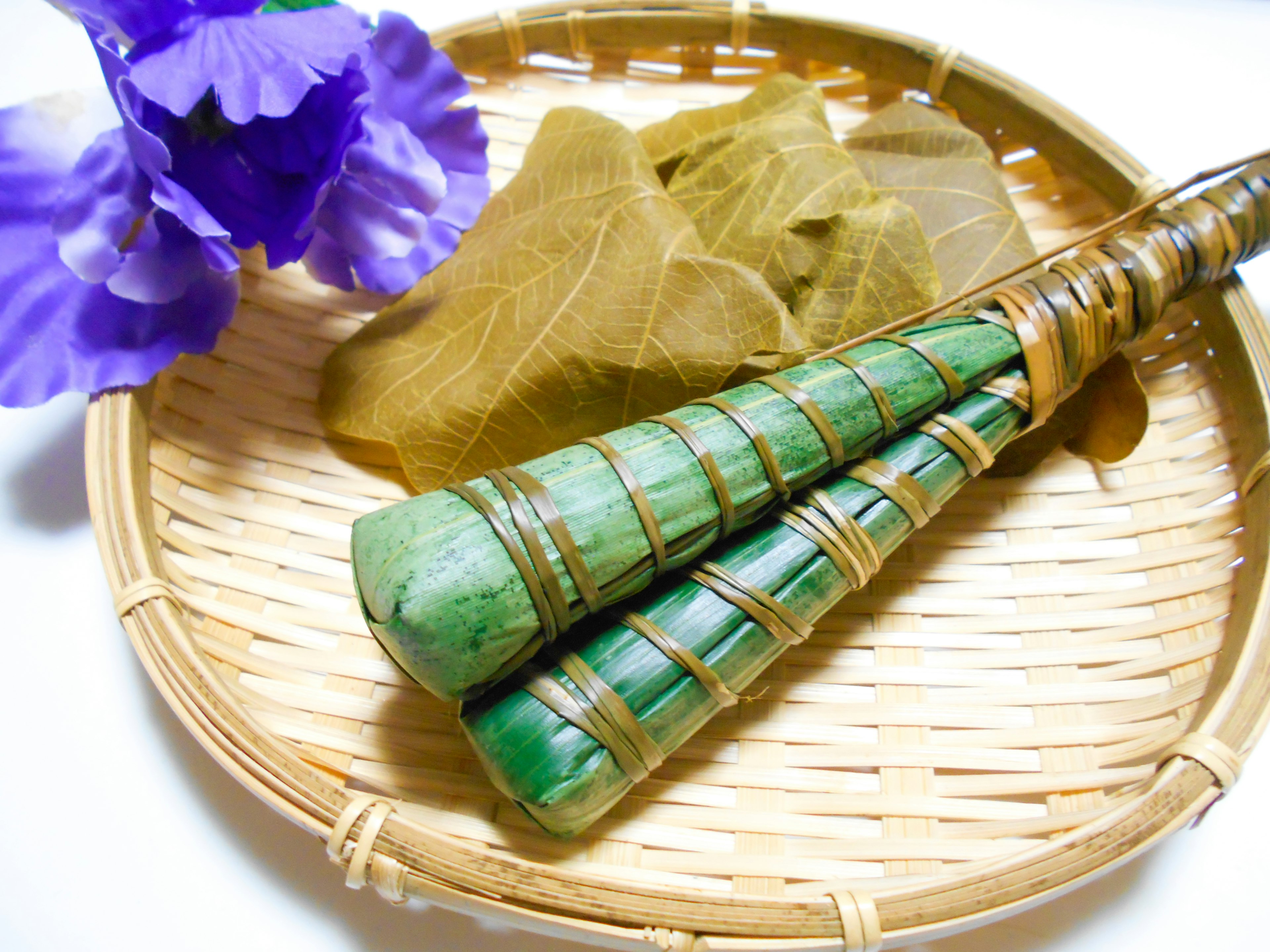 Image of green bamboo tools and light green cloth placed in a basket