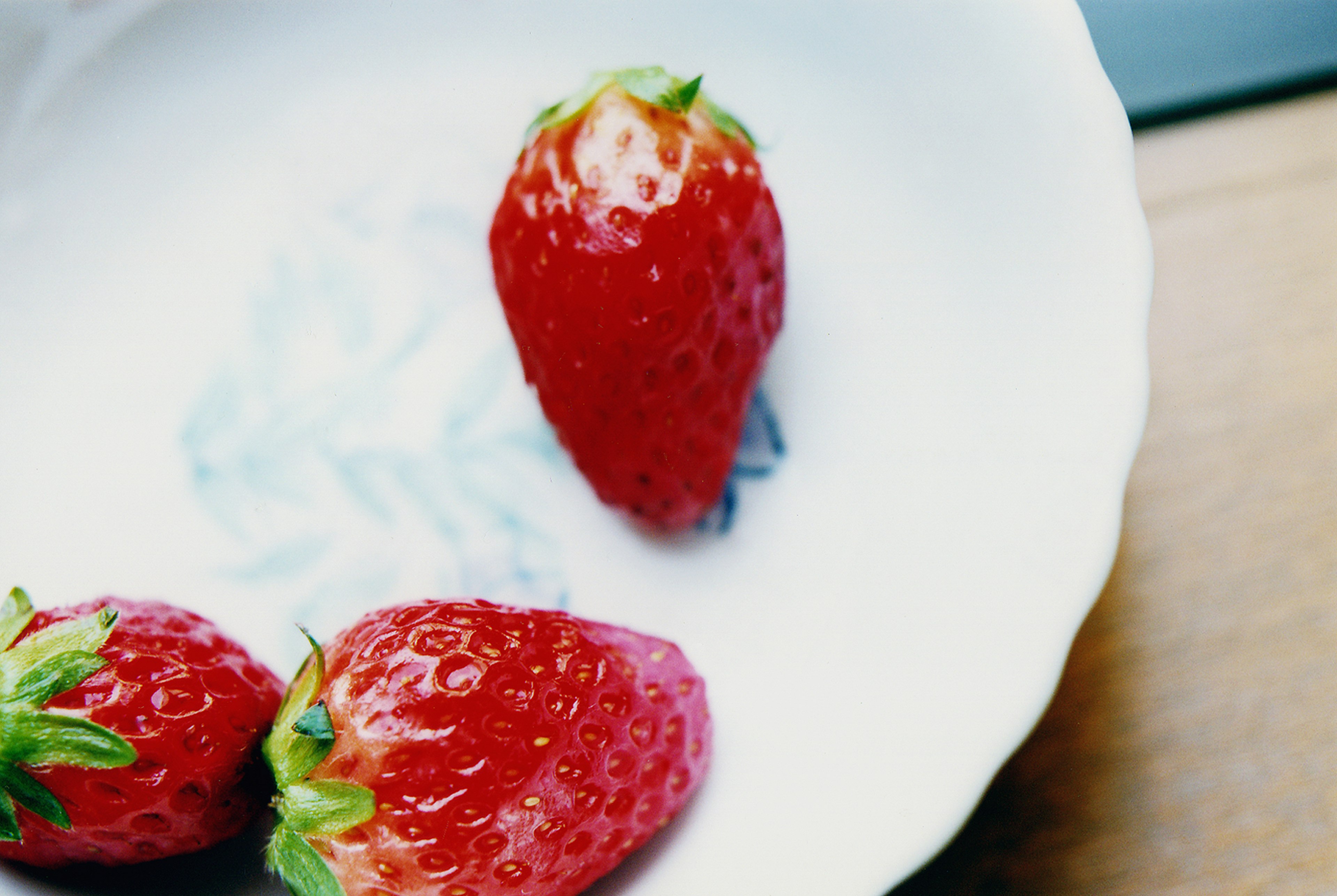 Fresh strawberries on a white plate