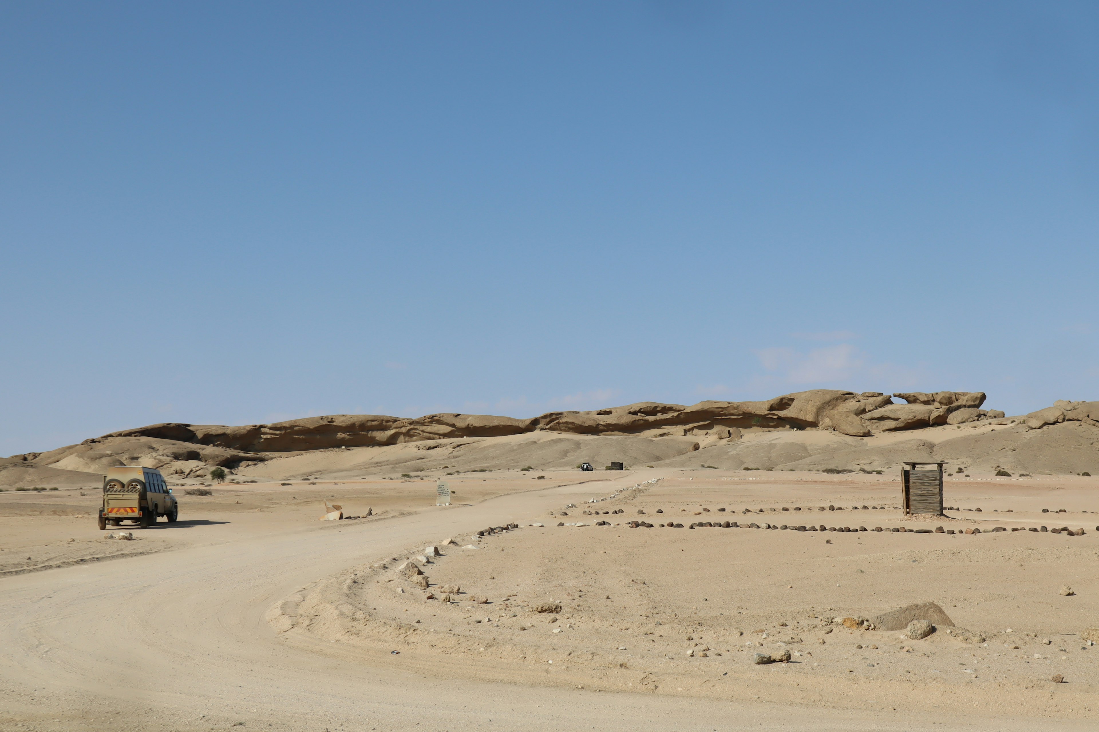 Winding road through a desert landscape with rocky hills