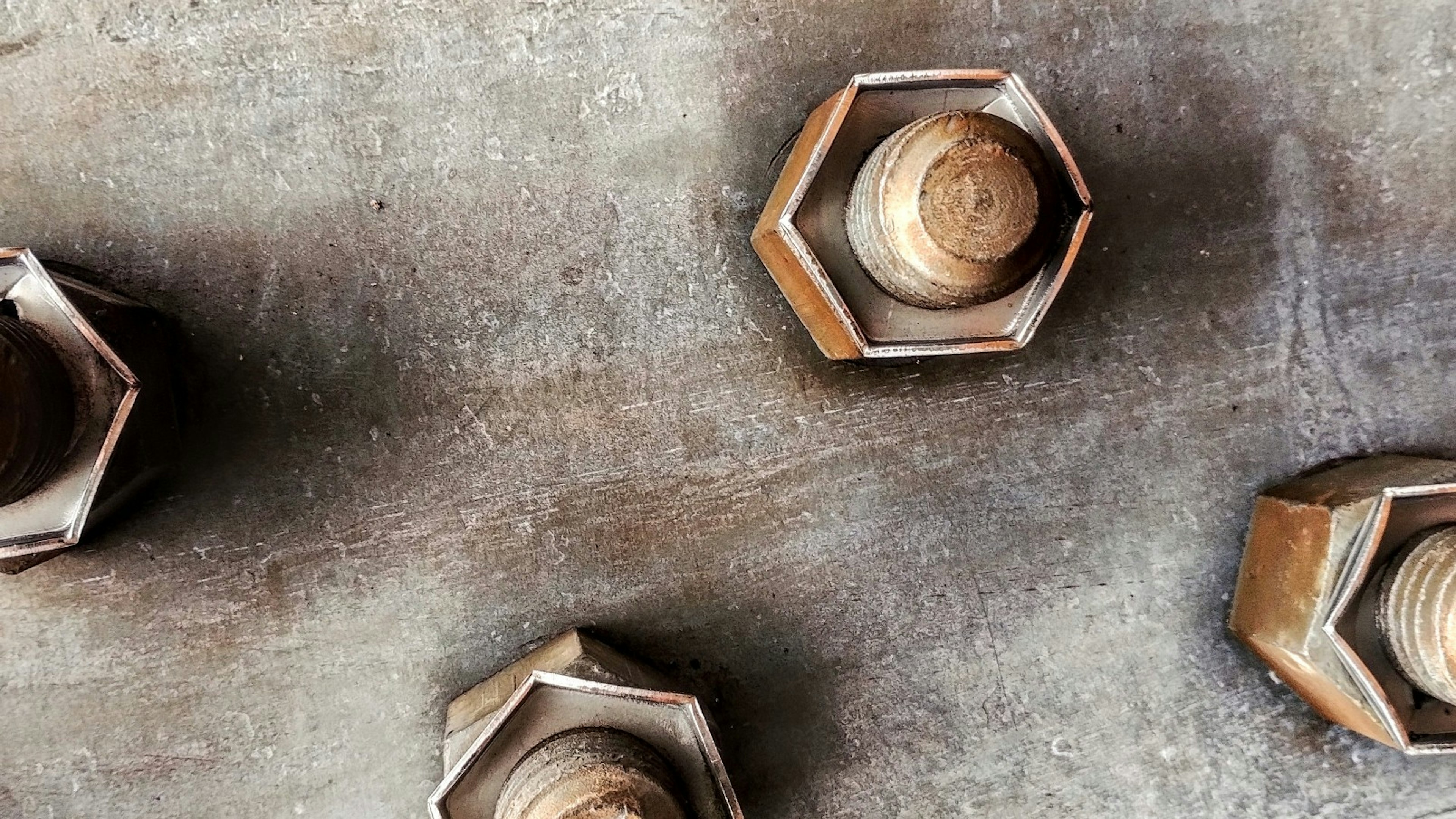 Metal nuts arranged on an industrial surface