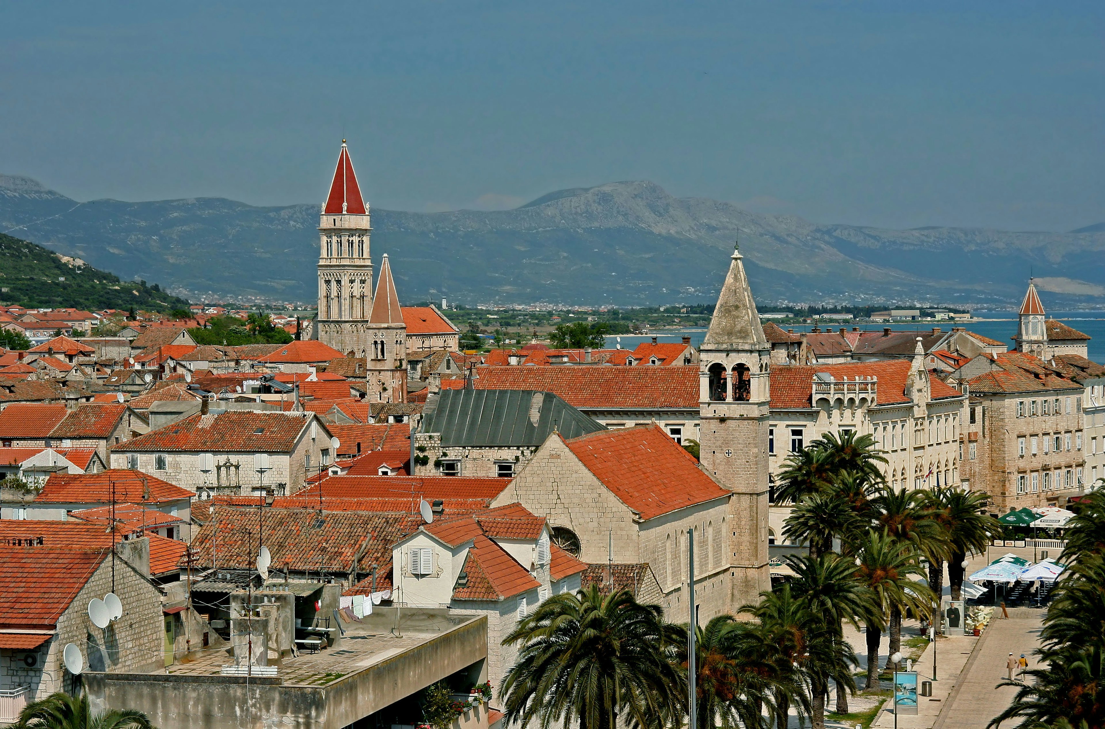 Panoramic view of Trogir featuring red-roofed buildings and towers