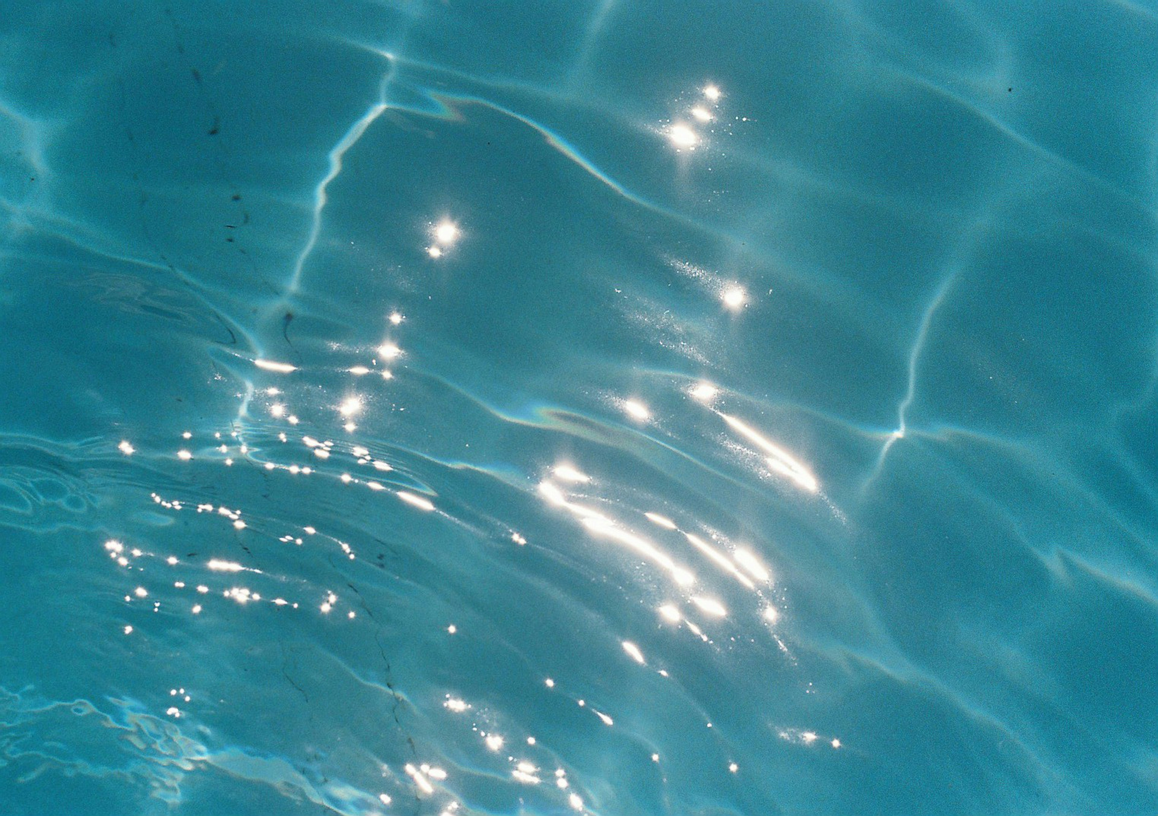 Rippling turquoise water with sparkling reflections