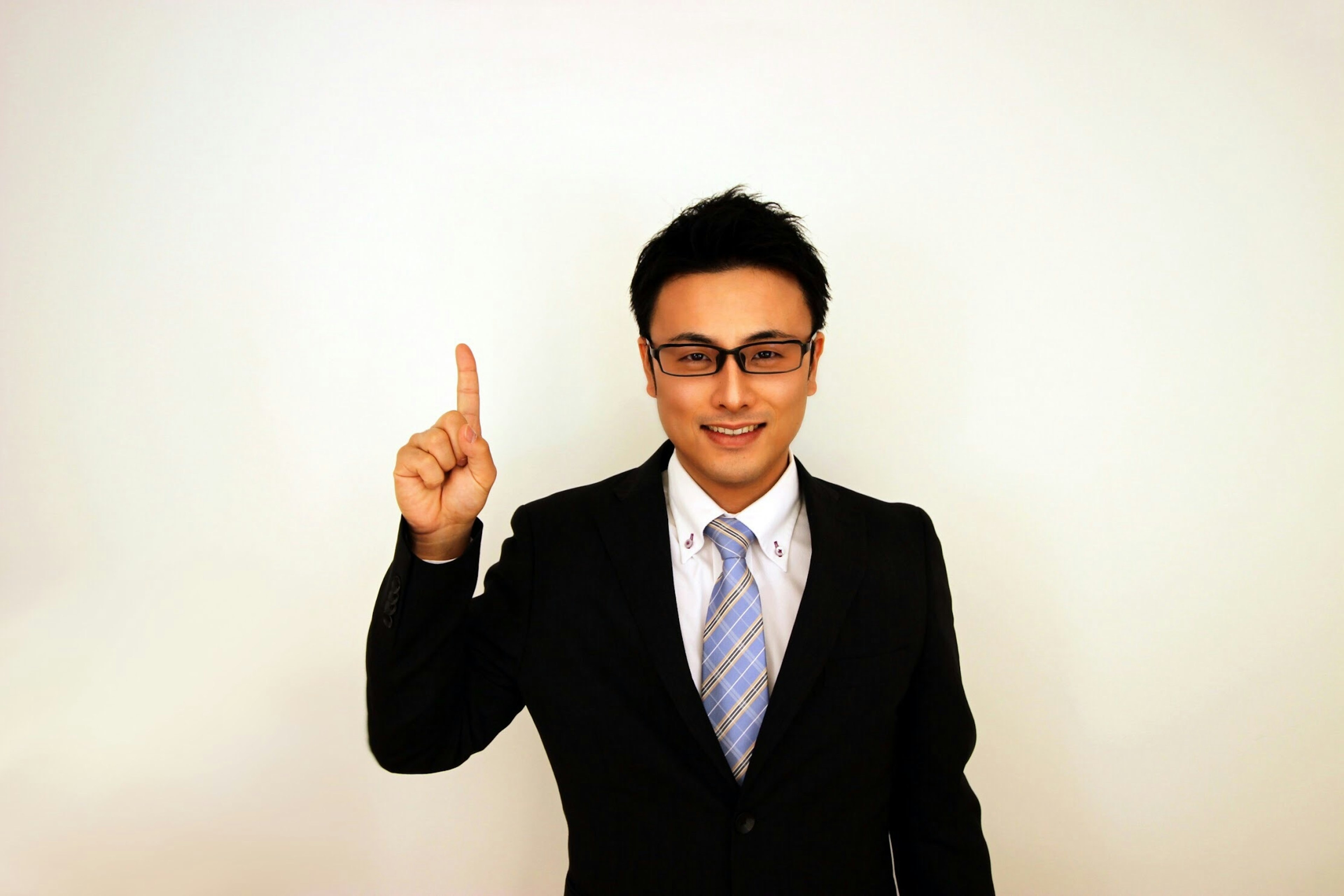 Man in a suit raising one finger