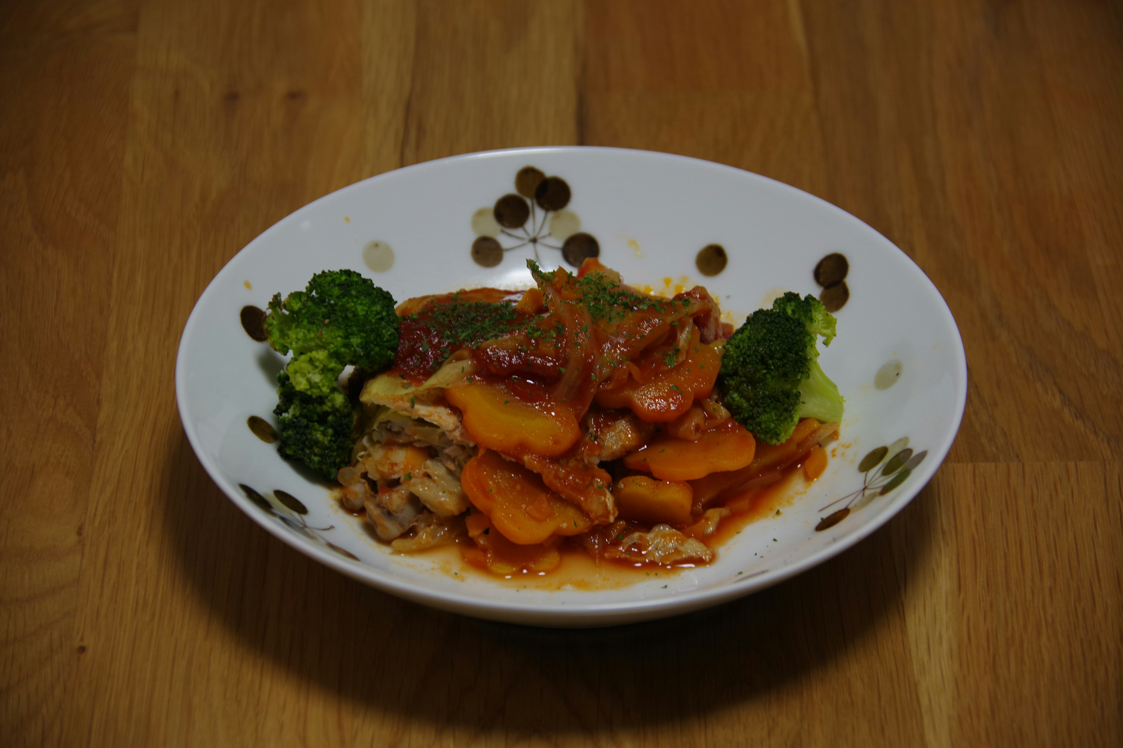 A colorful dish of vegetables and meat served on a white plate