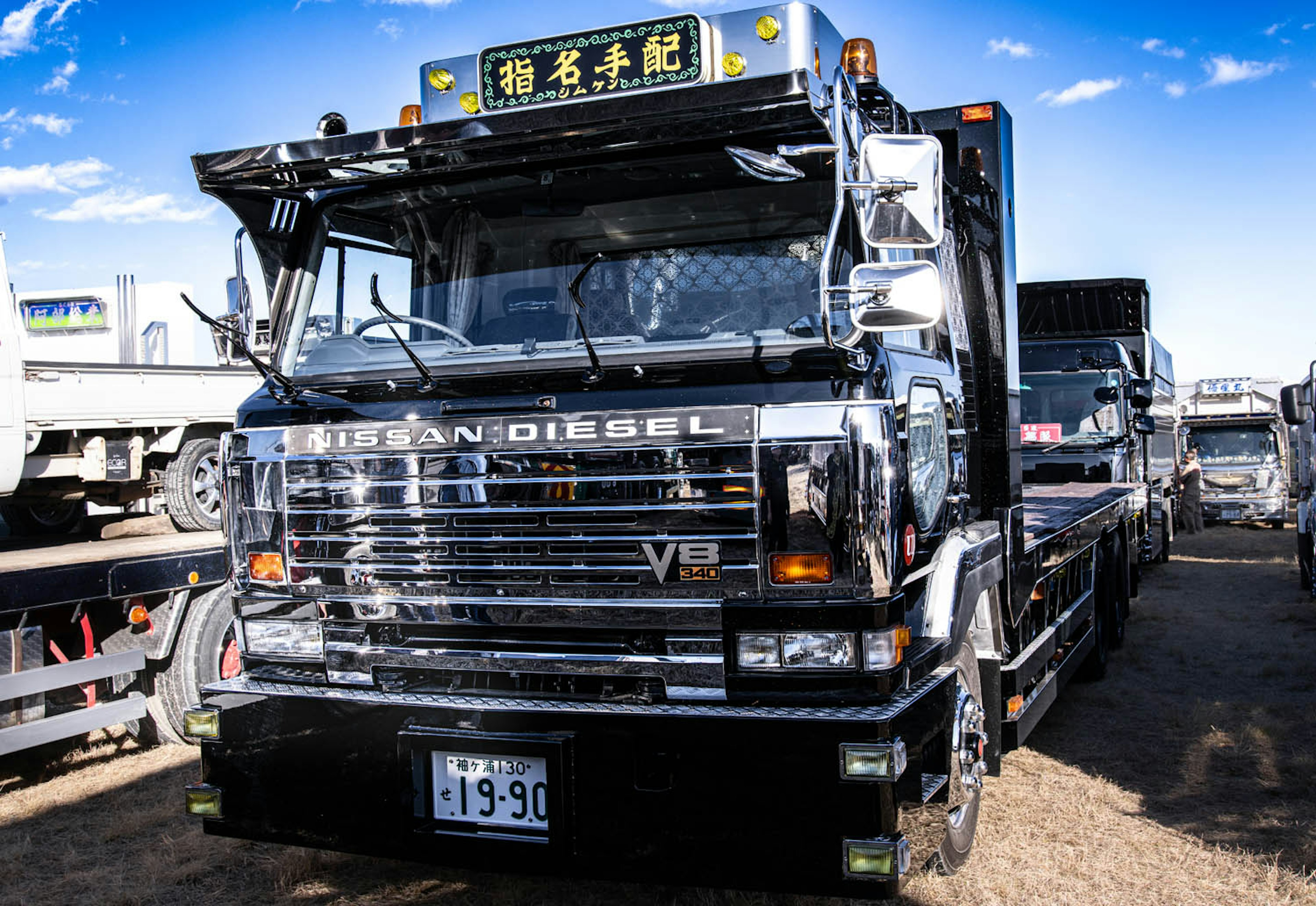 Black Nissan diesel truck parked showcasing its sleek design and shiny exterior