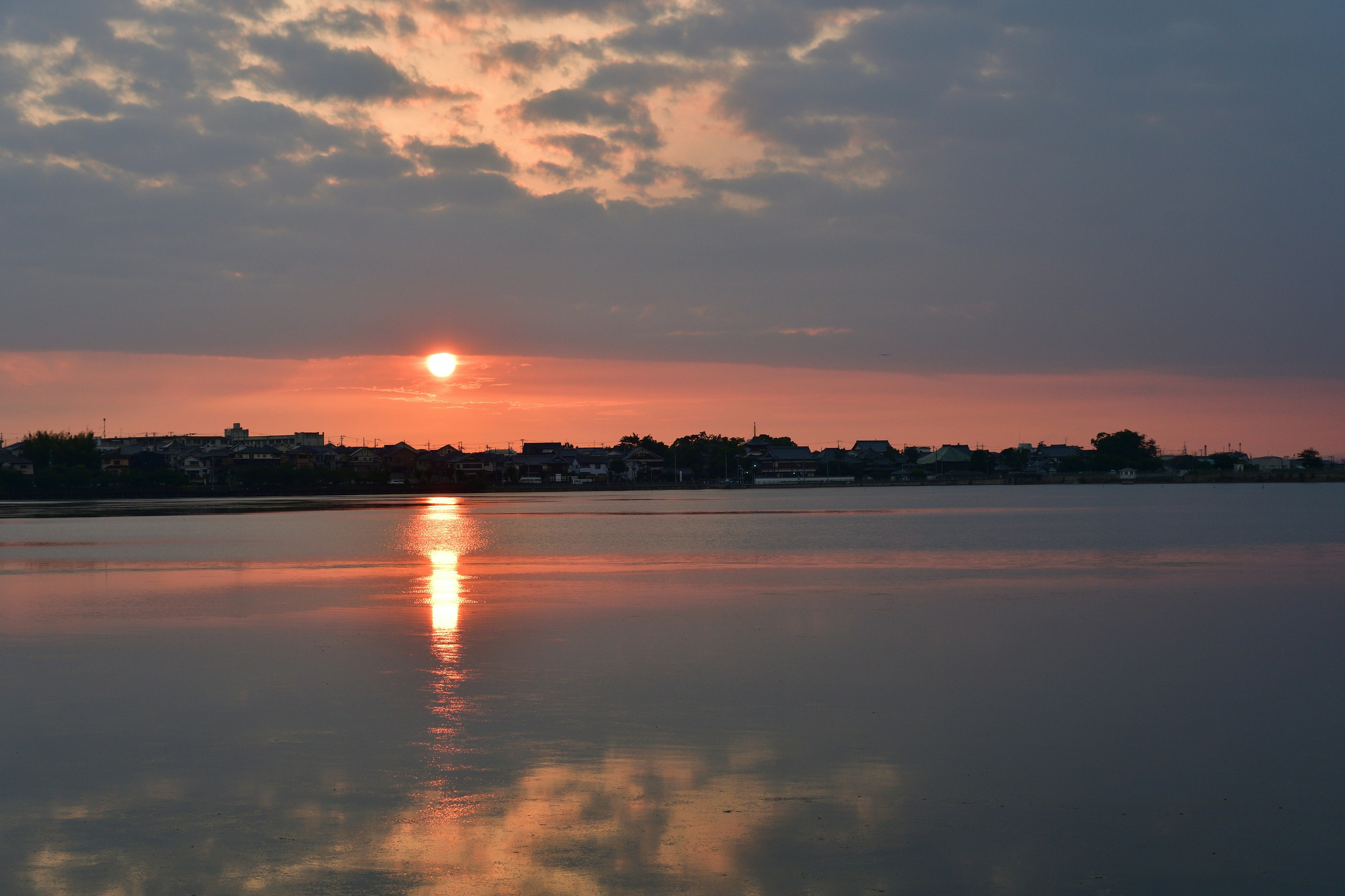 Serene landscape with sunset reflecting on water