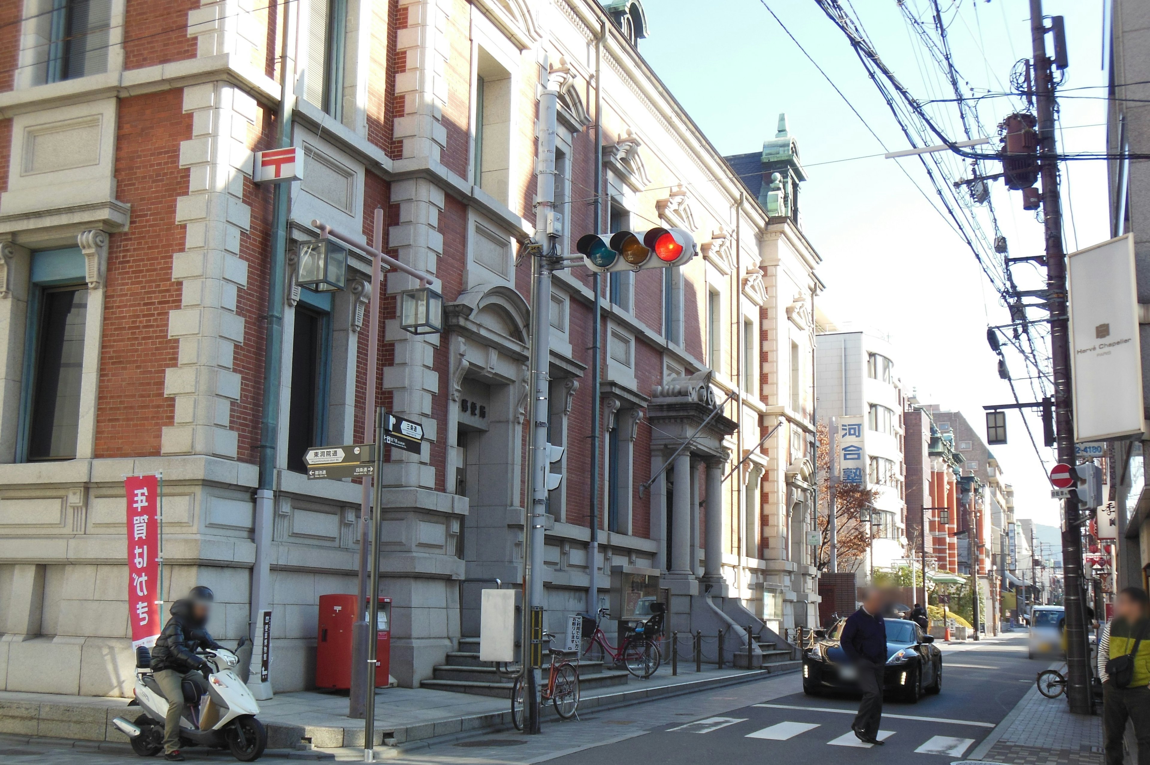 Street view featuring an old building and traffic signals