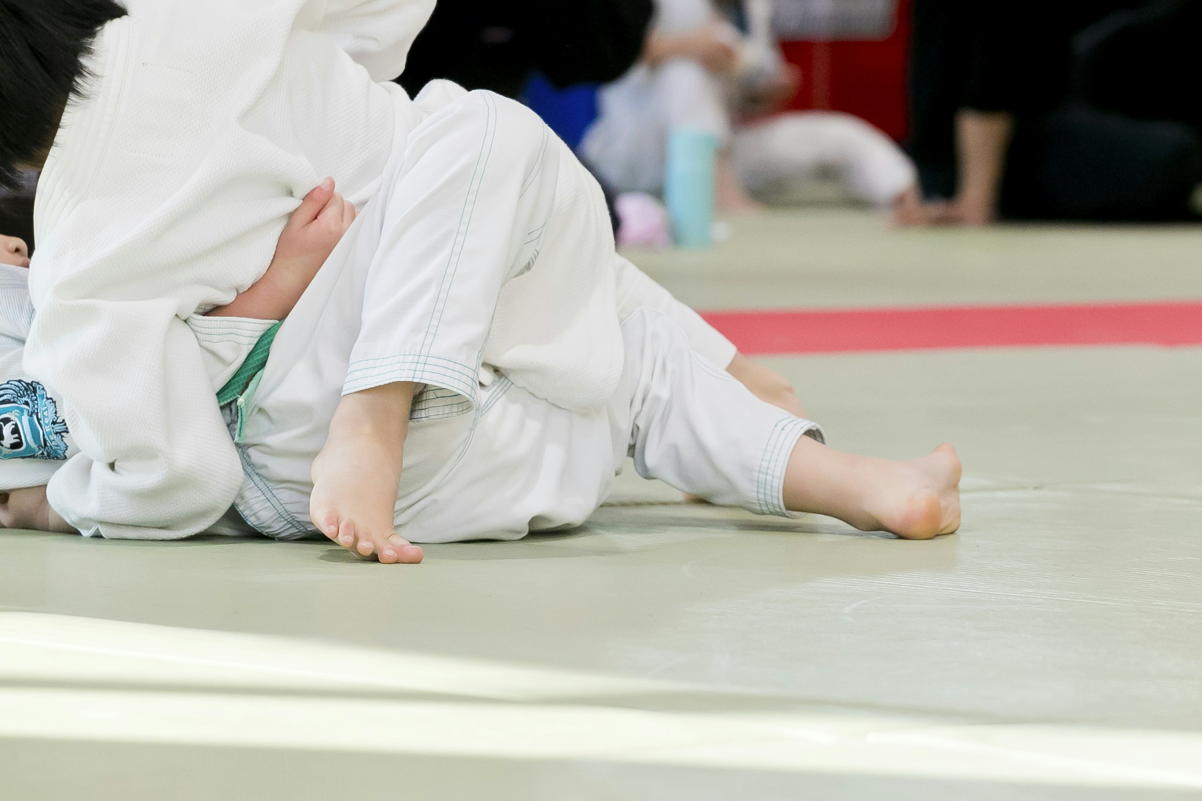 Acercamiento de los pies de niños durante un partido de judo