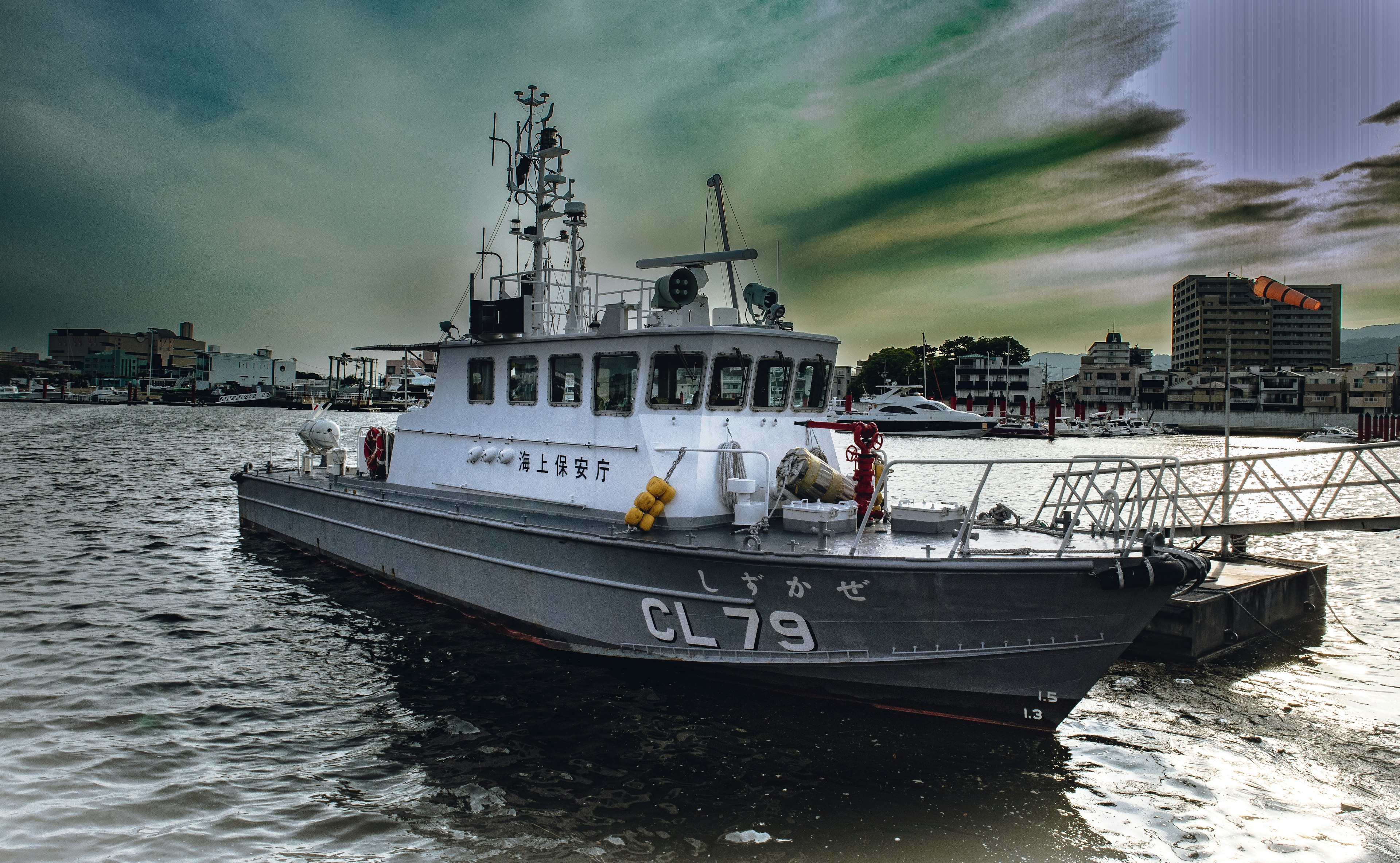 Image of the CL79 boat docked at the port with a beautiful sky and reflections on the water