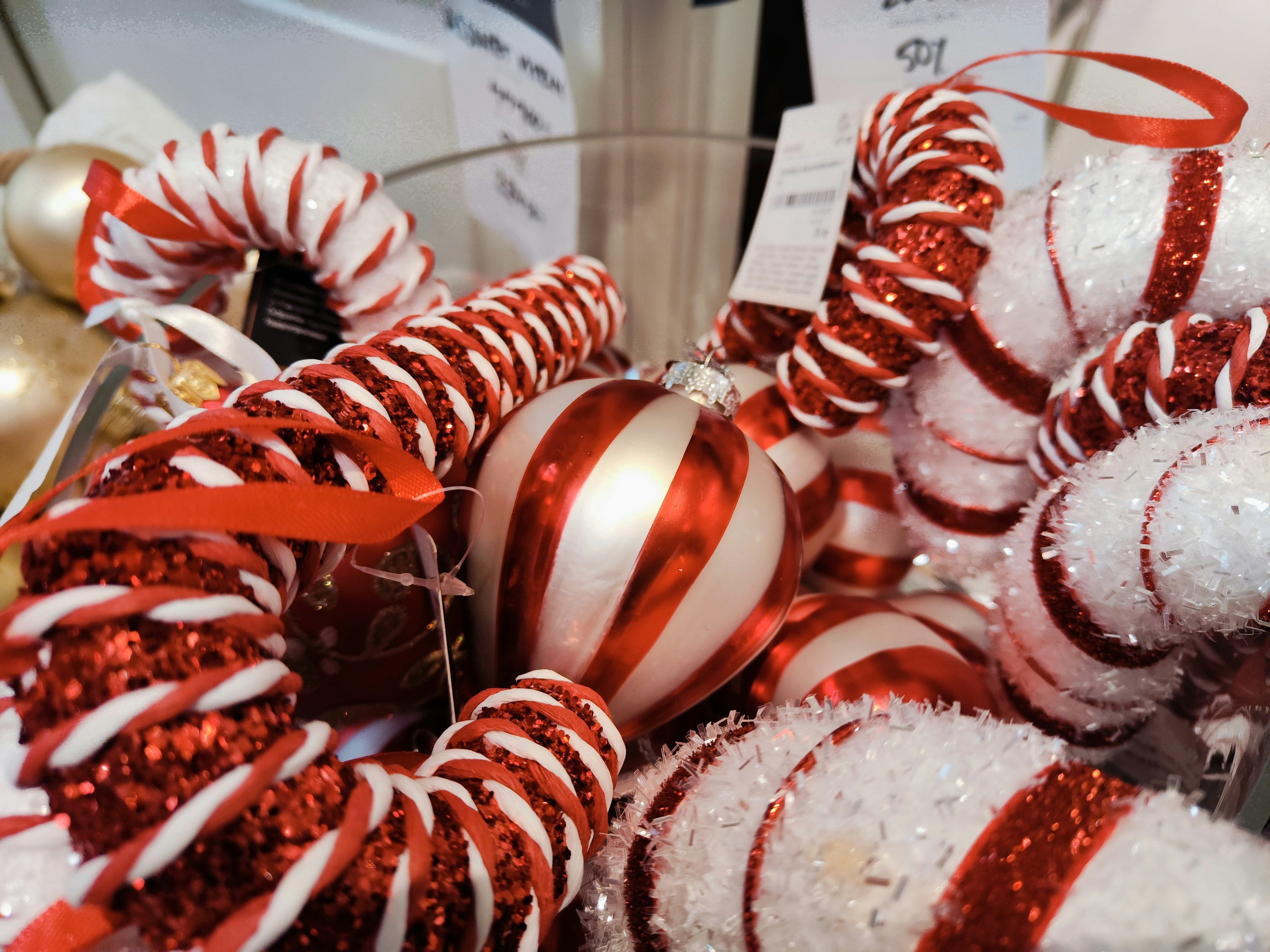 Bowl filled with red and white Christmas ornaments