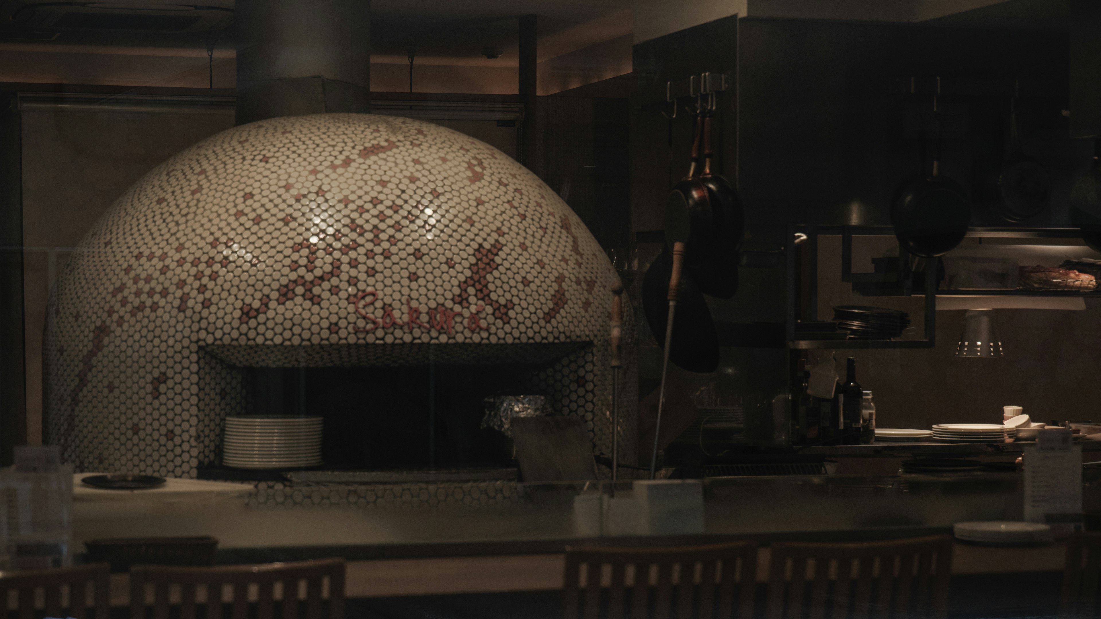 Interior of a restaurant featuring a large mosaic-tiled oven