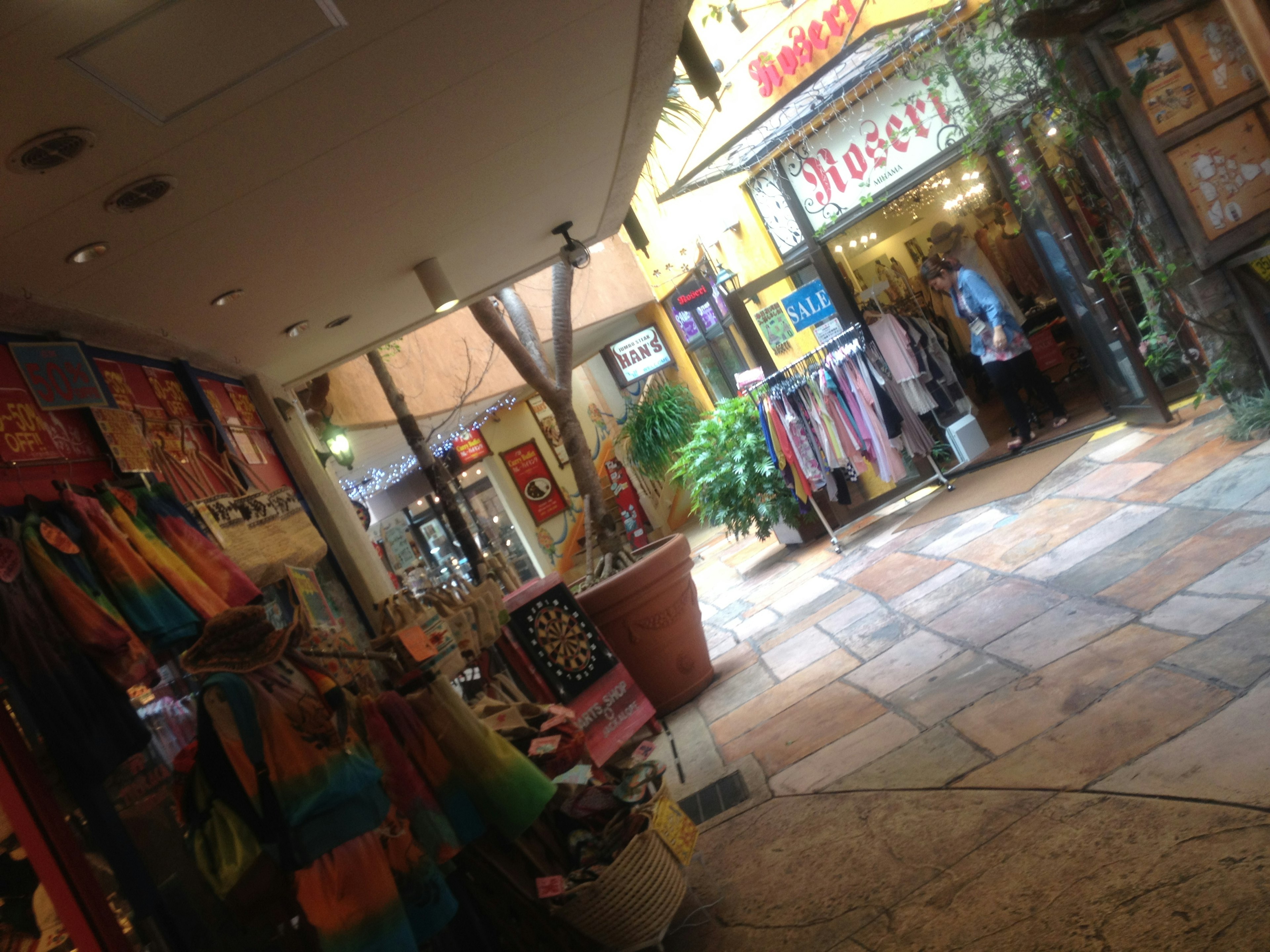 Colorful clothing and accessories displayed in a vibrant shopping alley