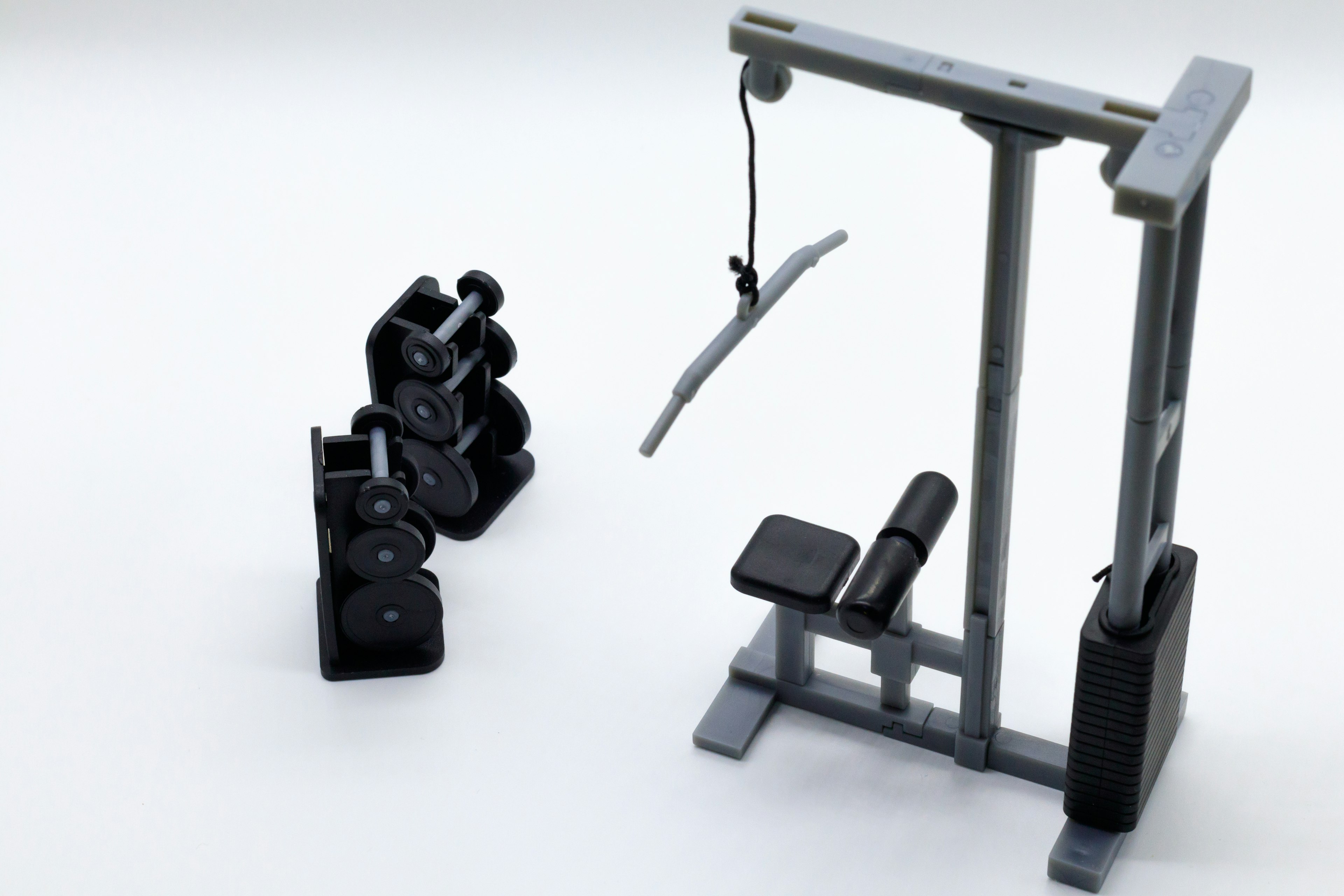 Fitness equipment set featuring dumbbells and a lat pulldown machine