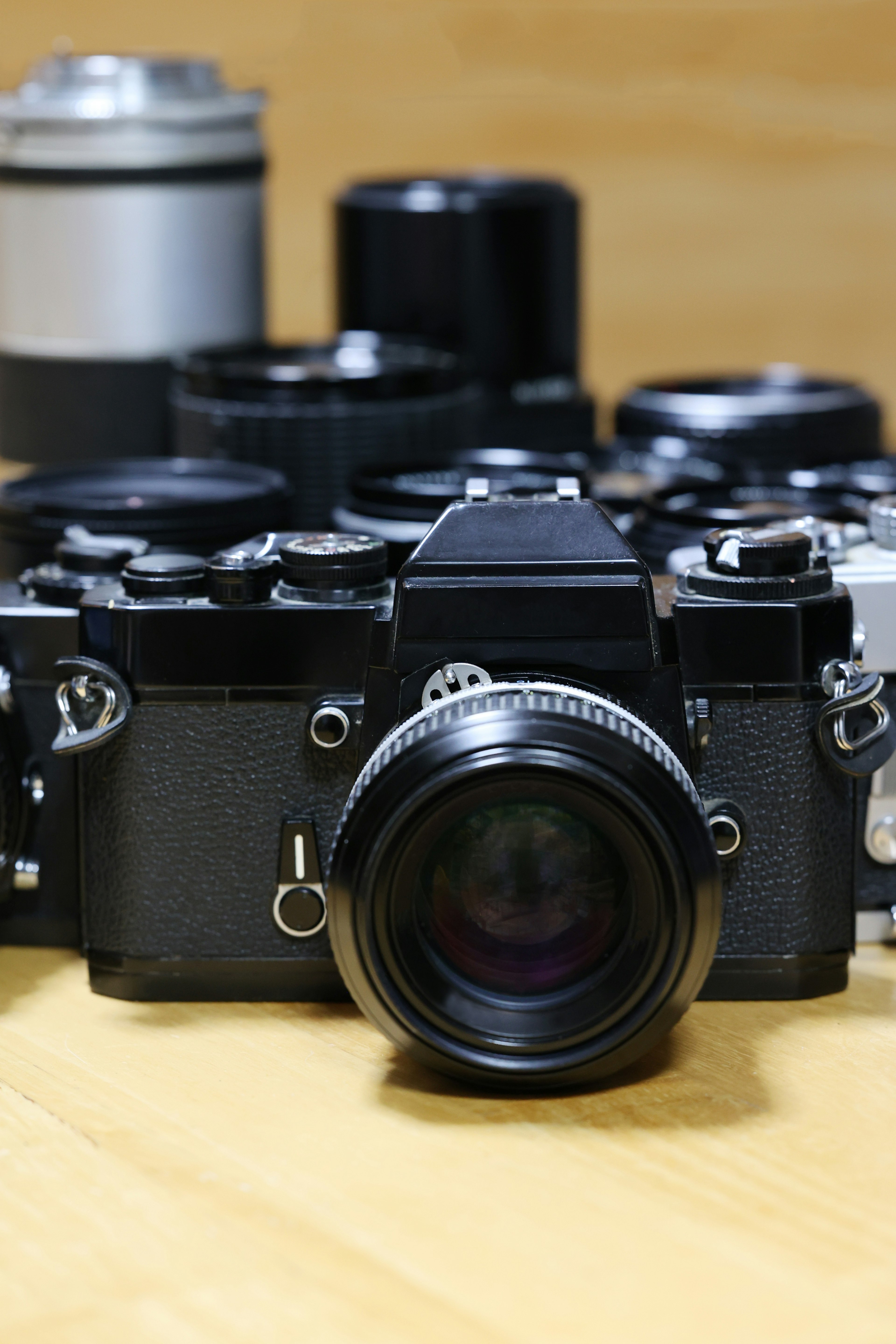 Vintage film camera with multiple lenses in background