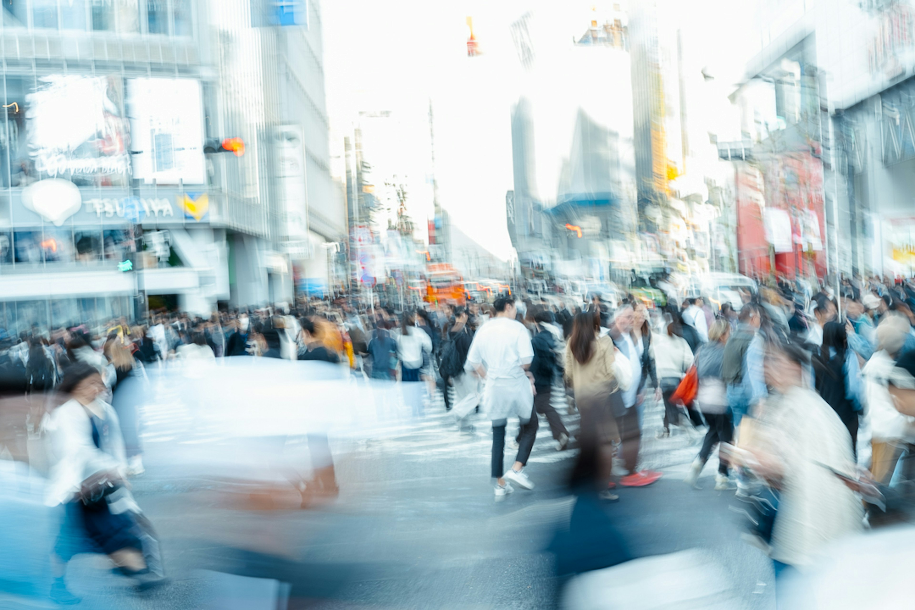 Immagine sfocata di un incrocio urbano affollato con persone che attraversano