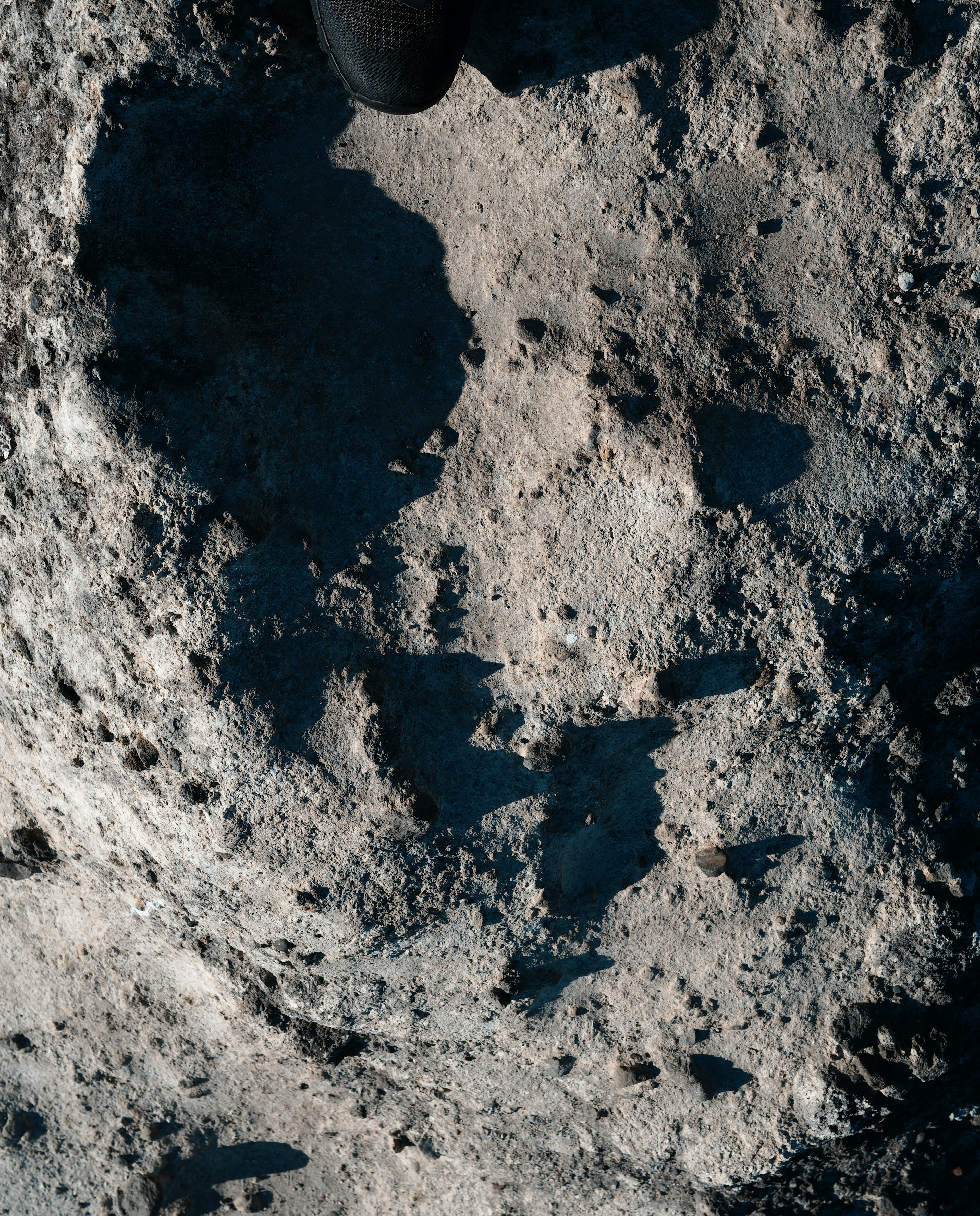 Close-up of lunar surface showing craters and shadows