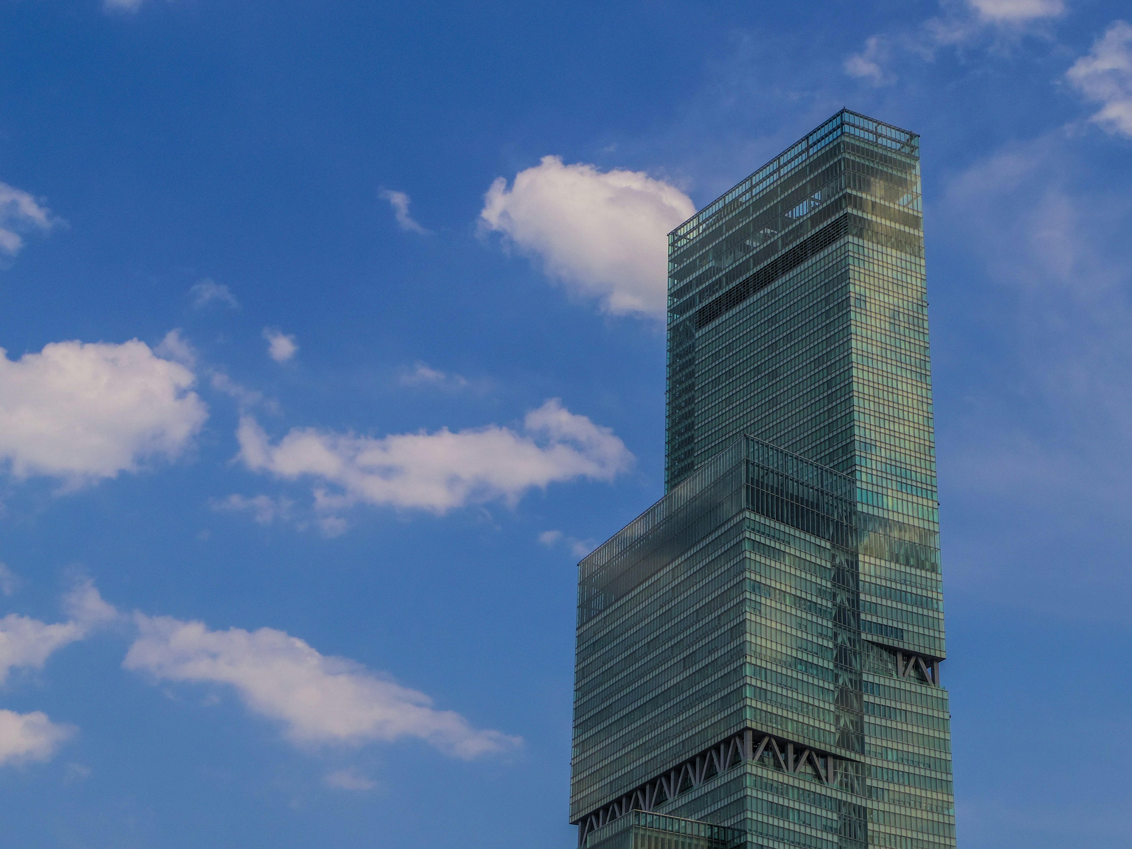 Image of a modern skyscraper against a blue sky