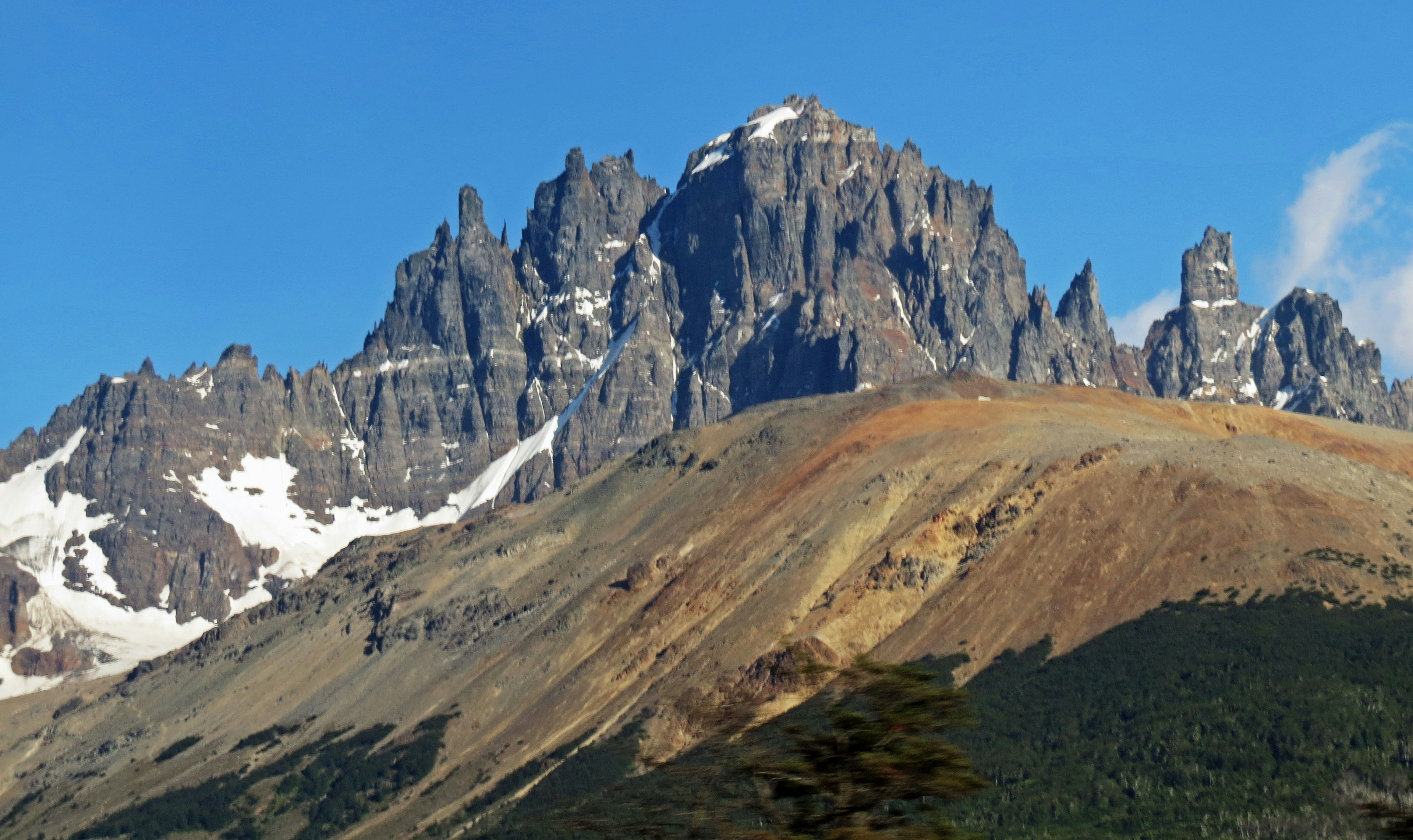 Stunning mountain landscape featuring towering rock formations and snow-capped slopes