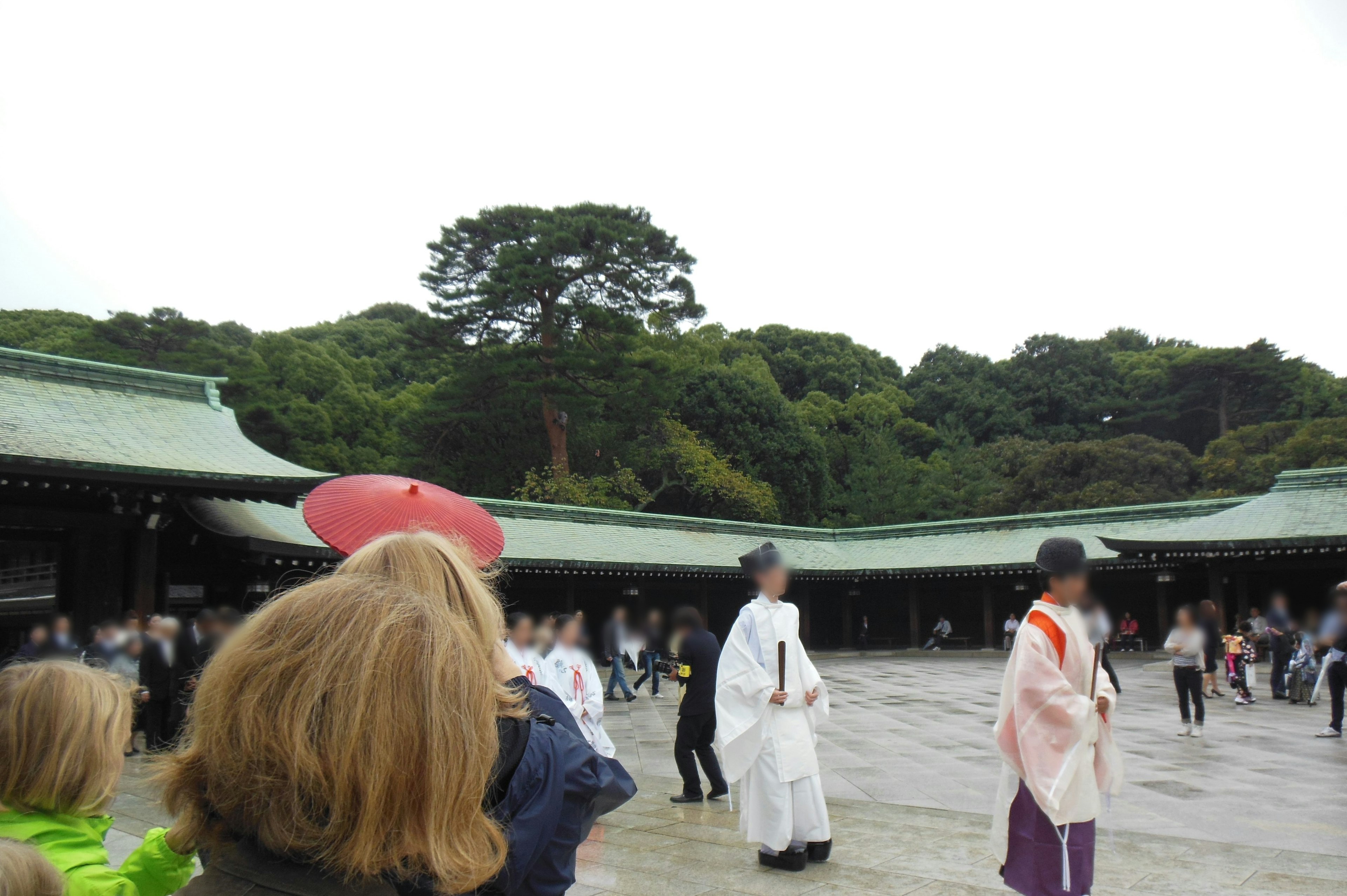 People in traditional attire gathered in a shrine courtyard