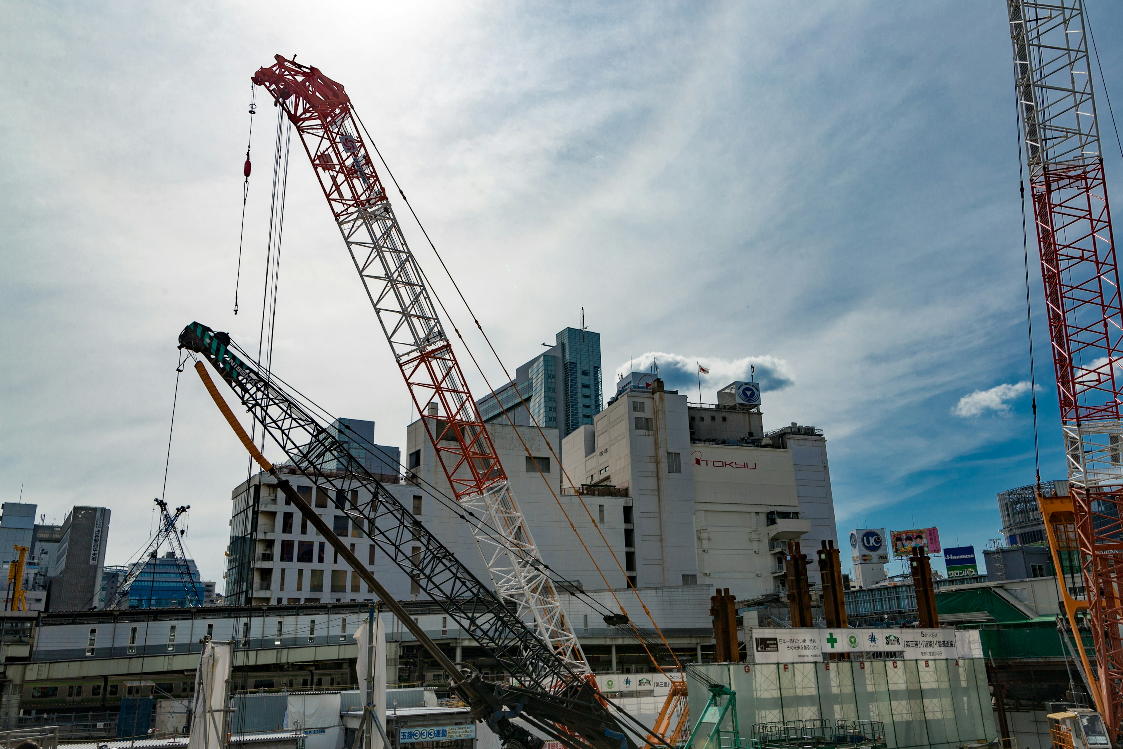 Construction site featuring cranes and a blue sky