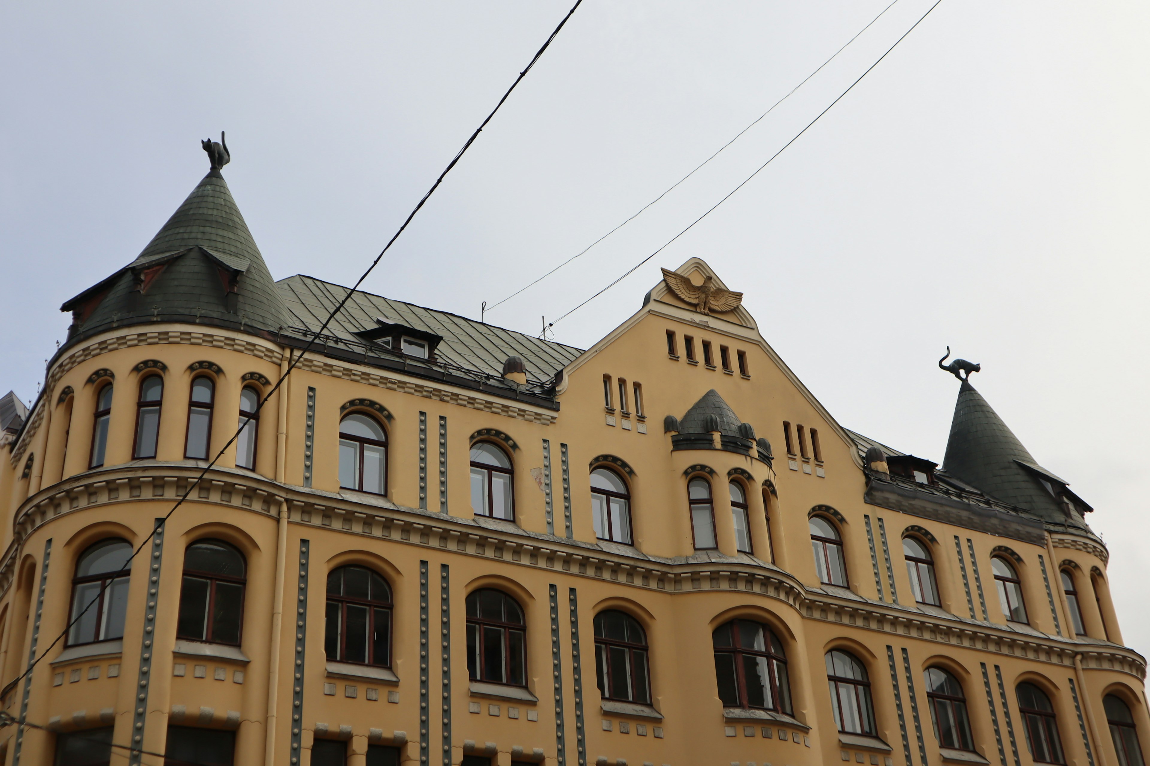 Yellow building with pointed roofs and decorative sculptures