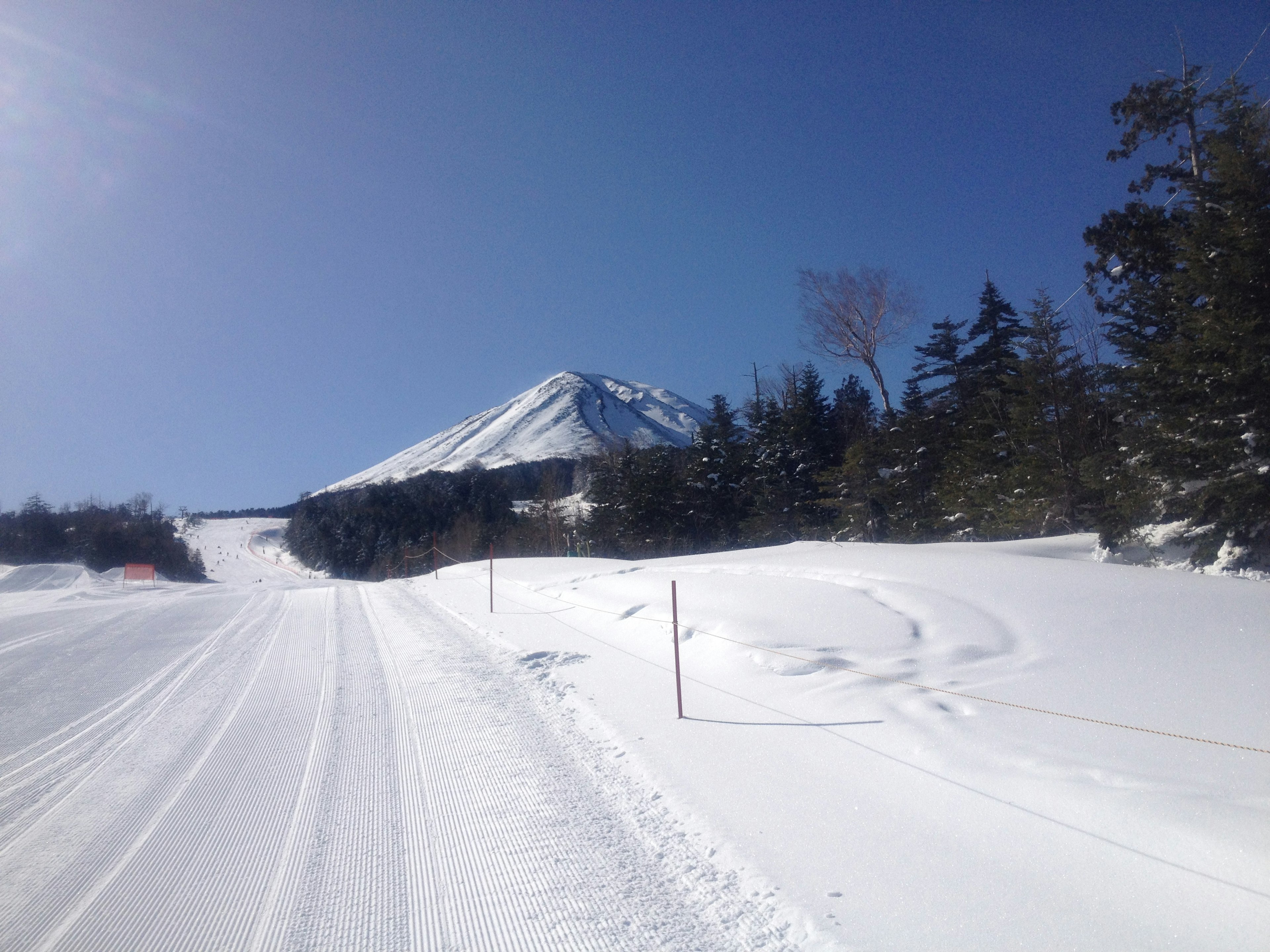 Snow-covered mountain landscape with clear blue sky