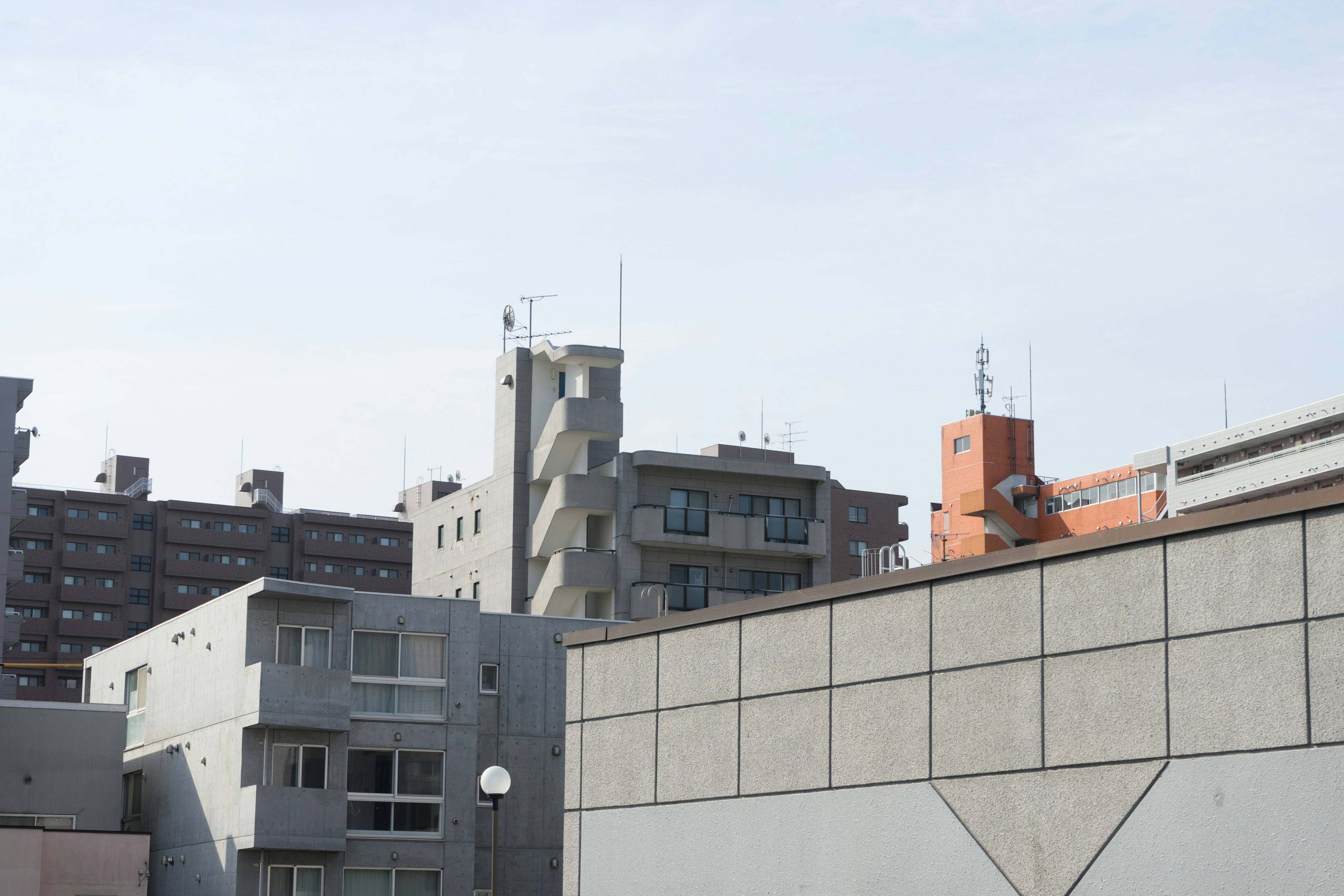 Urban landscape featuring concrete buildings against a blue sky