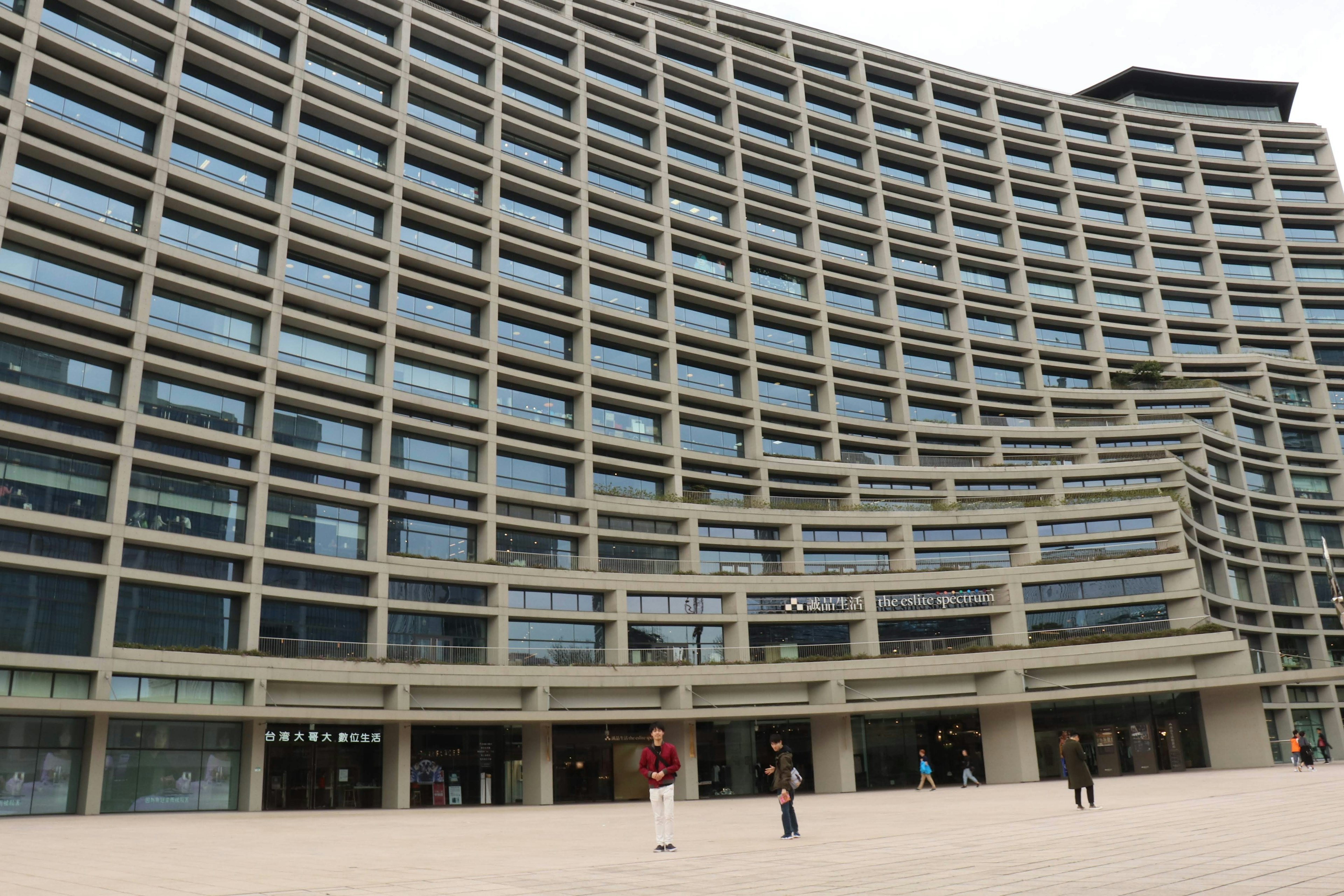 Curved modern building exterior with large glass windows